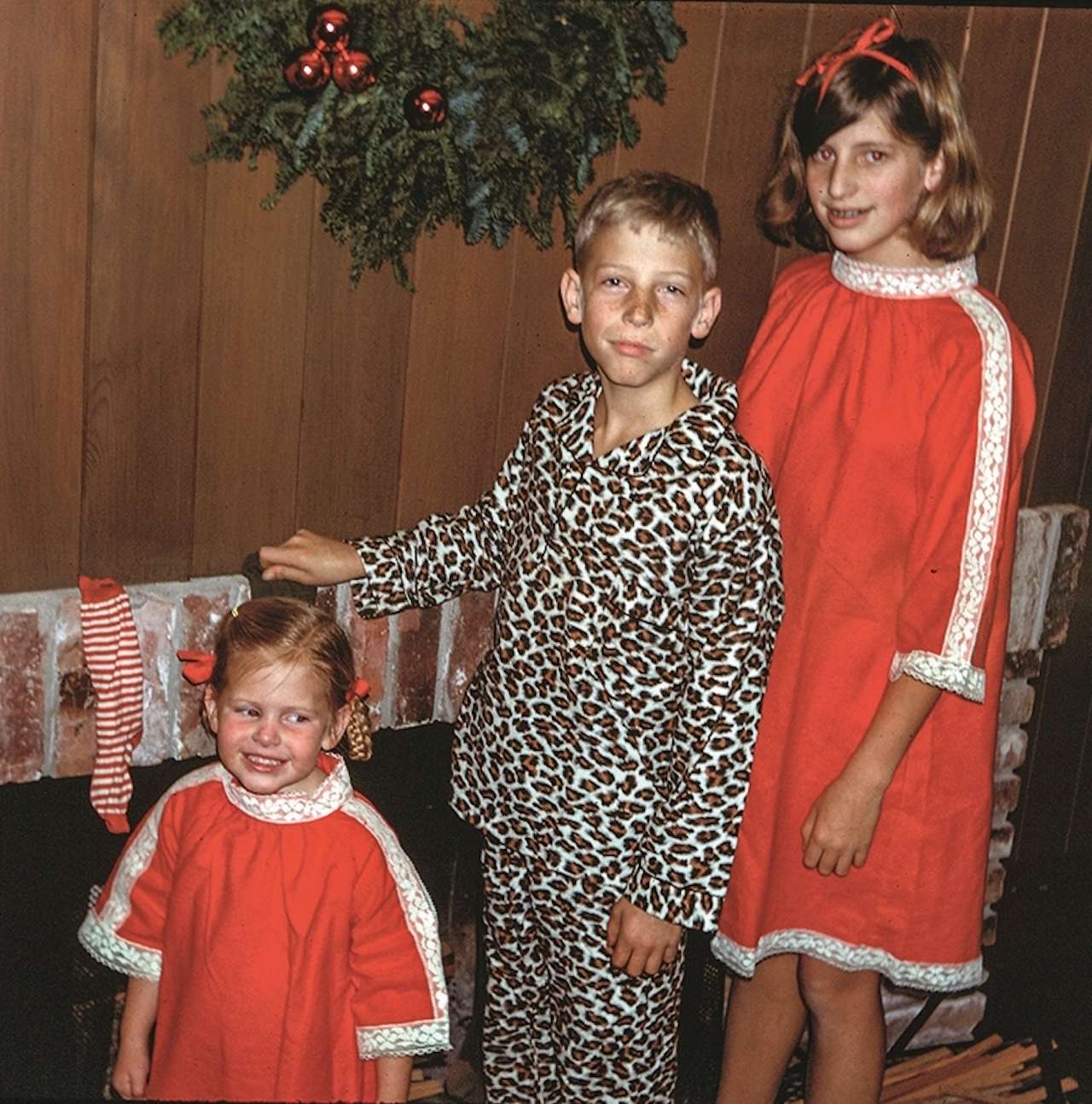 Libby Gates (Libby MacPhee), Bill Gates, and Kristi Gates (Kristi Blake) posing in front of fireplace, Seattle, Washington, December 1967.