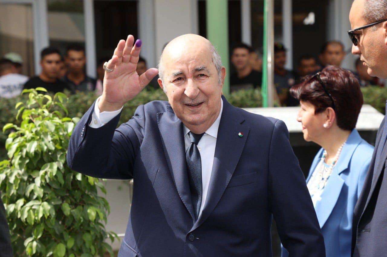 epa11591258 A handout picture provided by the Algerian Presidency Press Service shows Algerian President, Abdelmadjid Tebboune (L), reacting outside of a polling station during the Presidential elections in Algiers, Algeria, 07 September 2024. According to the National Independent Authority for Elections (ANIE), more than 24 million Algerians are called to the polls to elect a new president of the republic for a five-year term. Three candidates are running for this election; the national secretary of the Socialist Forces Front (FFS), Youcef Aouchiche, the president of the Movement of Society for Peace (MSP), Abdelaali Hassani Cherif, and the current president, Abdelmadjid Tebboune.  EPA/ALGERIAN PRESIDENCY / HANDOUT HANDOUT EDITORIAL USE ONLY/NO SALES
