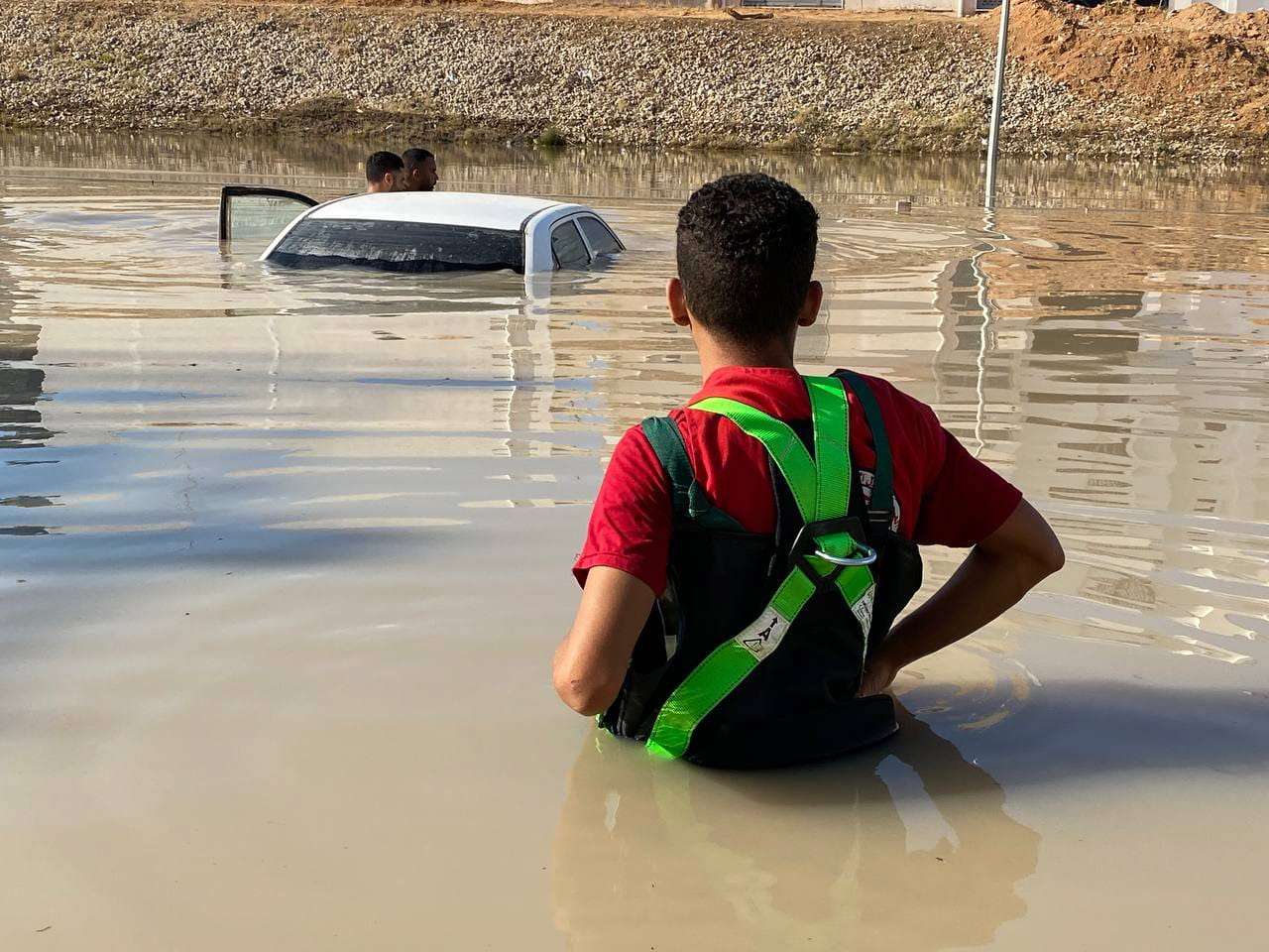 epa10858018 A handout photo made available by the Libyan Red Crescent shows members of the organization inspecting vehicles in the floods at an undefined location in eastern Libya, 11 August 2023 (issued 13 September 2023). The Red Cresent said that the floods caused by storm Daniel on 10 September in eastern Libya left thousands of people dead and missing.
     EPA/HANDOUT  HANDOUT EDITORIAL USE ONLY/NO SALES
