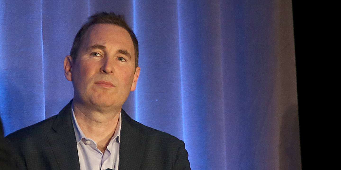 Western Digital CIO Steven Phillpott (left) speaks with CEO Andy Jassy (middle) and VMware CEO Parick P. Gelsinger (right) during a press conference announcing  Amazon's cloud service, AWS, partnering with VMware Cloud creating a new integrated cloud serv