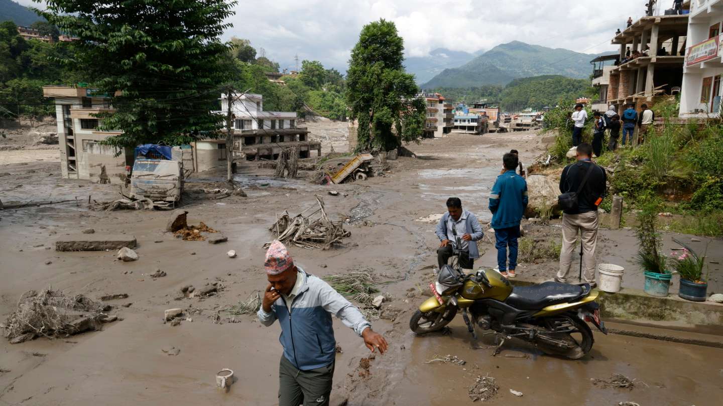 epa13191982 Villagers wade through flooded streets following a flash flood in Trishuli Bazar, Nuwakot district, Nepal, 26 August 2026. Several people were killed and multiple others were reported missing after a massive flash flood swept through Rasuwa and Nuwakot districts causing widespread destruction to settlements and infrastructure, according to local authorities.  EPA/NARENDRA SHRESTHA