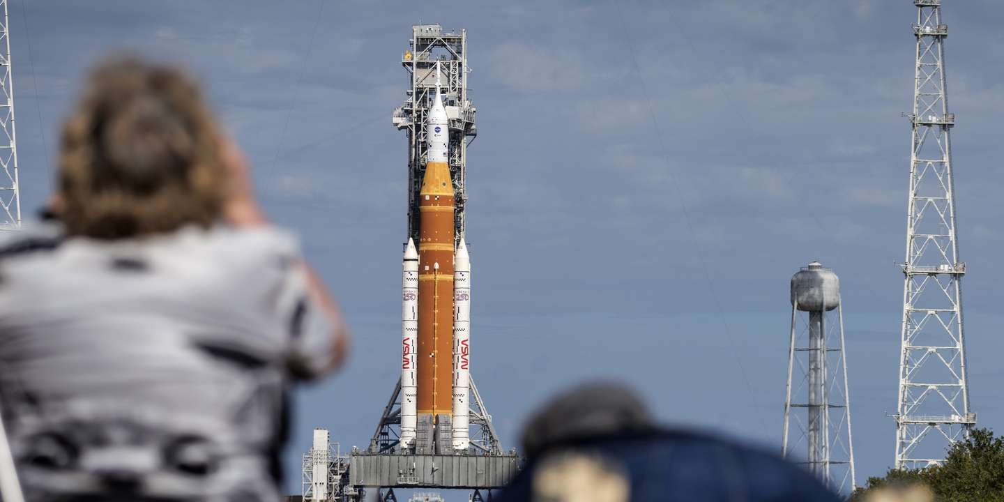 epa12693138 Members of the media photograph the Space Launch System (SLS) rocket with an Orion capsule, part of the Artemis 2 mission, that is docked at Launch Pad 39B at the Kennedy Space Center in Titusville, Florida, USA, 30 January 2026. According to NASA, the Artemis II mission will conduct a crewed lunar flyby, the second in NASA's Artemis program. It will be the first human mission beyond low Earth orbit since 1972, designed to test spacecraft systems in preparation for future Moon landings.  EPA/CRISTOBAL HERRERA-ULASHKEVICH