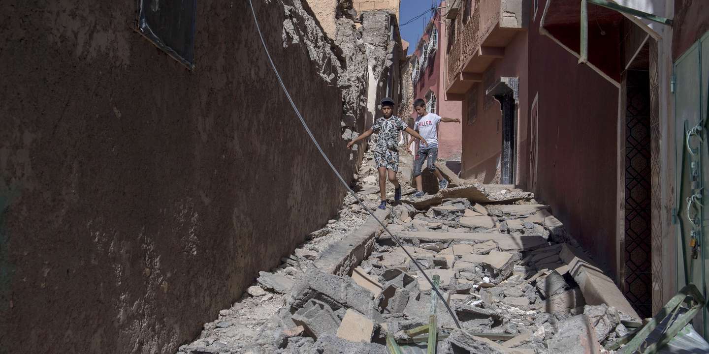 epa10850133 Two children walk among debris of damaged buildings following an earthquake in Marrakesh, Morocco, 09 September 2023. A powerful earthquake that hit central Morocco late 08 September, killed at least 820 people and injured 672 others, according to a provisional report from the country's Interior Ministry. The earthquake, measuring magnitude 6.8 according to the USGS, damaged buildings from villages and towns in the Atlas Mountains to Marrakesh.  EPA/JALAL MORCHIDI