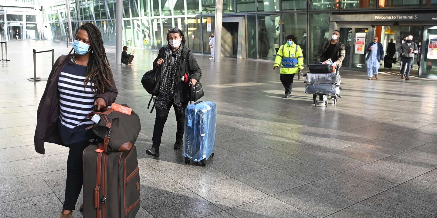 epa09014604 International travelers are escorted to a bus as they are moved to a Radison Blu Hotel for quarantine from Heathrow Airport, Heathrow, Britain, 15 February 2021. Passengers arriving from 33 'red list' countries, including South Africa and the United Arab Emirates, must be quarantined in hotels rooms for 10 days at their own expense. The policy is in response to the emergence of new variants of the novel coronavirus that are more resistant to existing vaccines.  EPA/NEIL HALL