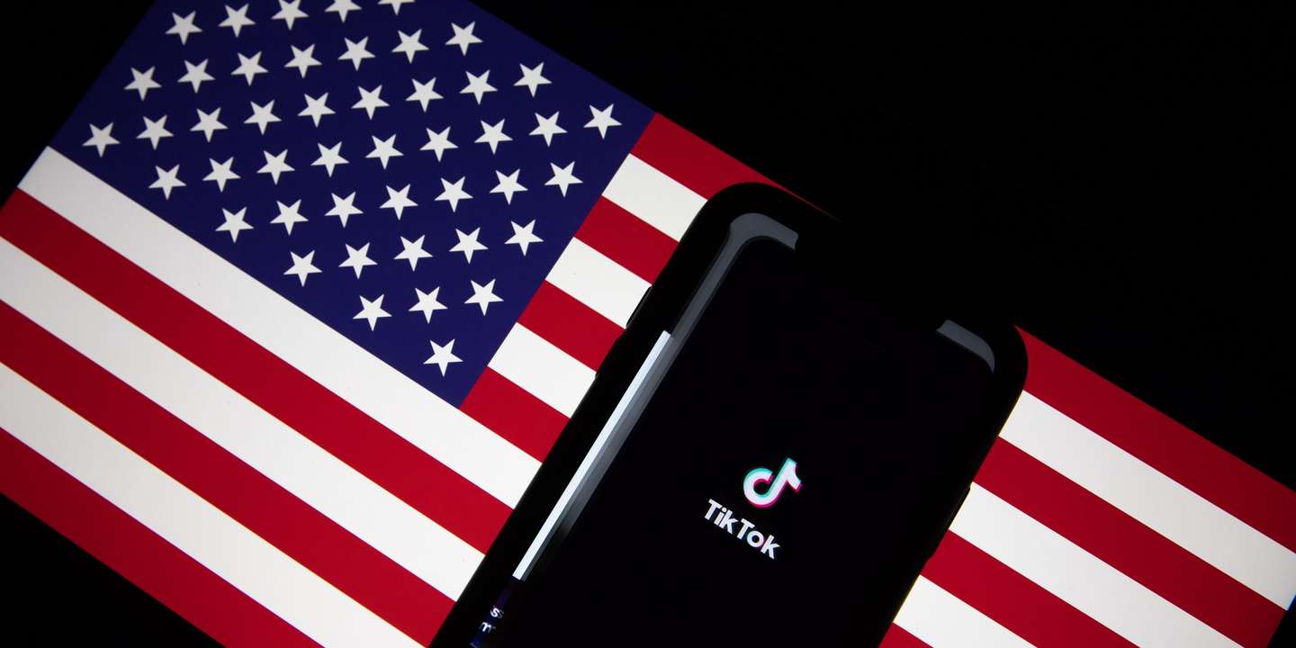 epa08685859 A generic illustration shows the logo of Chinese internet media app TikTok on a phone, and the US flag on a laptop screen, in Beijing, China, 21 September 2020. Chinese-owned mobile app WeChat was set to stop operation in the U.S. on midnight 20 September 2020.  EPA/ROMAN PILIPEY