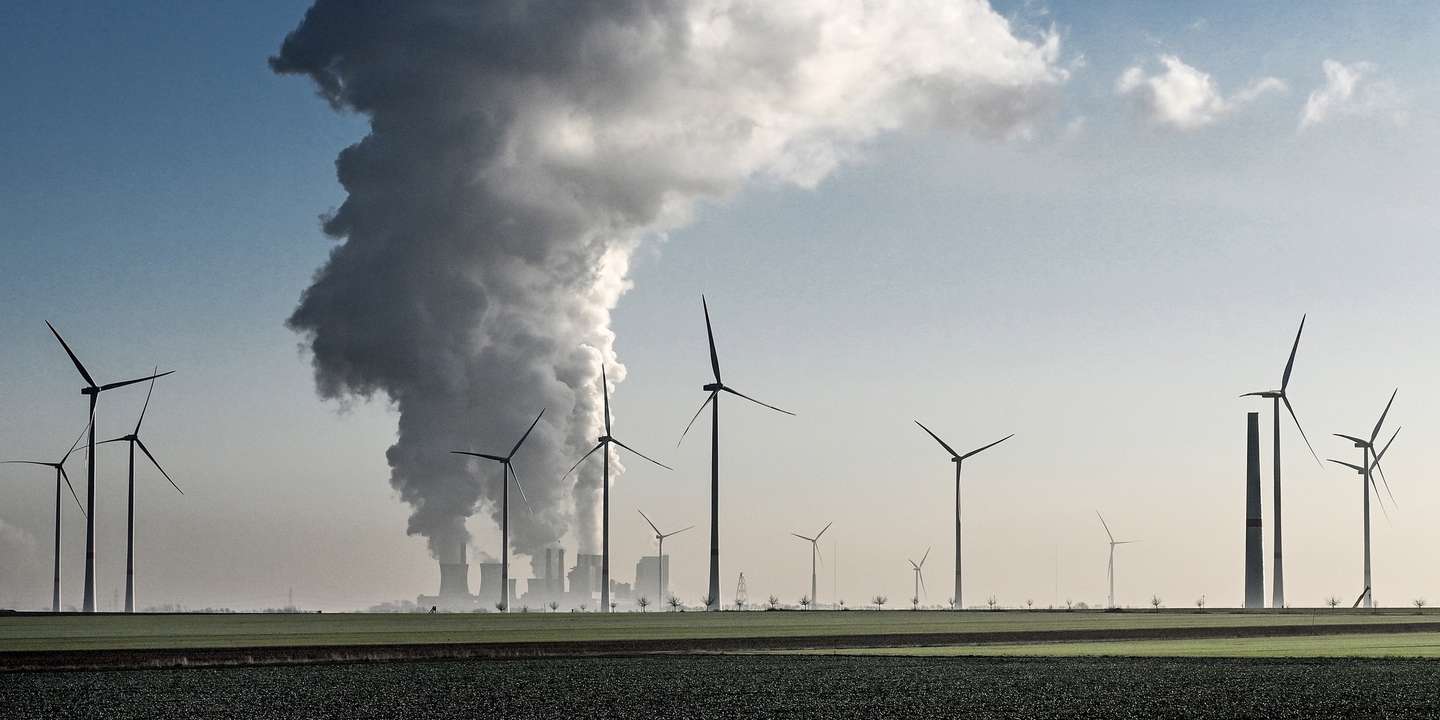 epaselect epa09678248 Wind turbines stand next to the lignite-fired power plant Neurath operated by German energy supplier RWE near Grevenbroich, Germany, 11 January 2022. The German Federal Ministry for Climate Protection, Environment and Energy (BMU) is calling for immediate climate protection measures. One key point is the reform of the Renewable Energy Sources Act. To ensure that significantly more electricity is generated from wind and solar energy in the future, it is planned to increase the corresponding tender volumes. In addition, it is necessary to reconcile the expansion of wind power with the protection of species. According to the ministry, the targets set by the previous black-red-led government for this year will be missed by a wide margin, and next year will also be difficult.  EPA/SASCHA STEINBACH