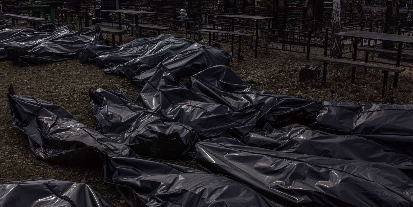 epa09877034 Bodies of killed people, which were brought to the cemetery, lay on the ground in body bags, in Bucha, northwest of Kyiv, Ukraine, 07 April 2022. Hundreds of tortured and killed civilians have been found in Bucha and other parts of the Kyiv region after the Russian army retreated from those areas. The growing evidence shows that the Russian forces are believed to be behind the atrocities when they were controlling the areas. Russian troops entered Ukraine on 24 February resulting in fighting and destruction in the country and triggering a series of severe economic sanctions on Russia by Western countries.  EPA/ROMAN PILIPEY