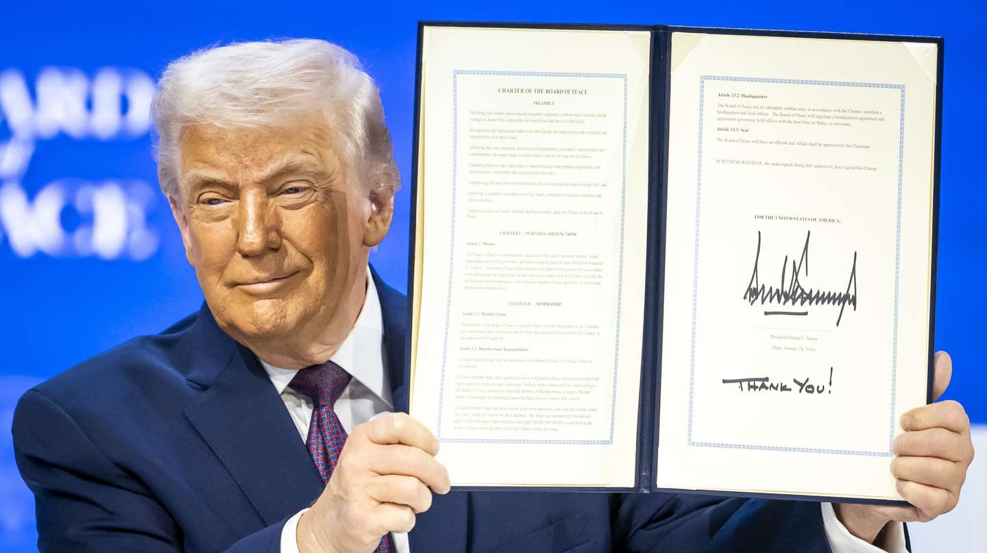 epa12670370 US President Donald Trump holds a signed founding charter at the 'Board of Peace' meeting during the 56th annual meeting of the World Economic Forum (WEF), in Davos, Switzerland, 22 January 2026. The 2026 summit, running from 19 to 23 January and held under the theme 'A Spirit of Dialogue,' brings together global political leaders, corporate executives, and scientists to address international challenges.  EPA/GIAN EHRENZELLER