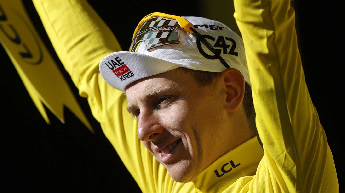 epa13130682 Slovenian cyclist Tadej Pogacar of UAE Team Emirates XRG celebrates on the podium retaining the overall leader's yellow jersey after winning Stage 19 of the Tour de France over 127.9km from Gap to Alpe d'Huez, France, 24 July 2026.  EPA/YOAN VALAT