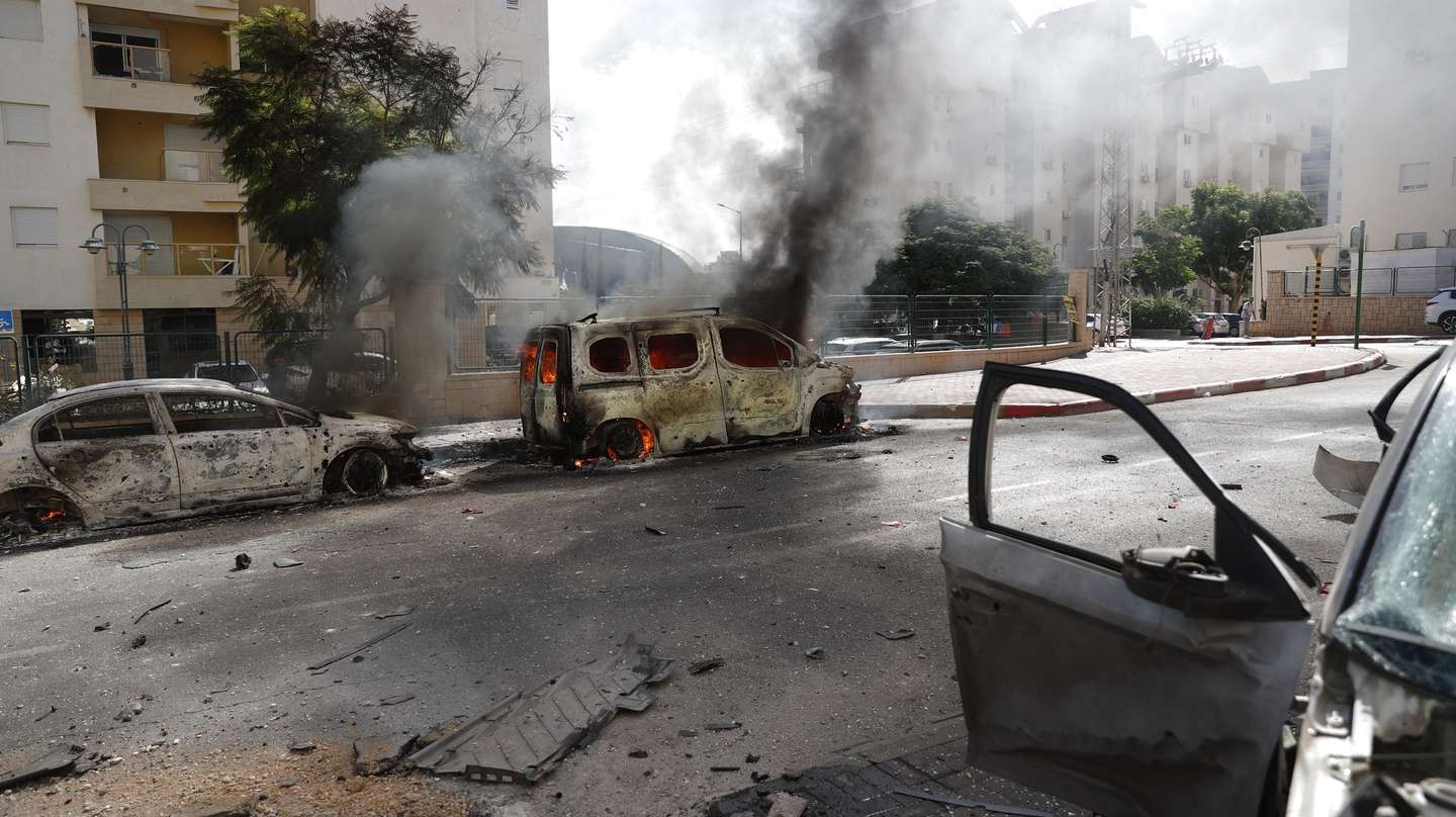 epa10904782 Wrecked cars and damaged buildings in the Israeli city of Ashkelon following rocket launches from Gaza, 07 October 2023. Rocket barrages were launched from the Gaza Strip early Saturday in a surprise attack claimed by the Islamist movement Hamas.  EPA/ATEF SAFADI