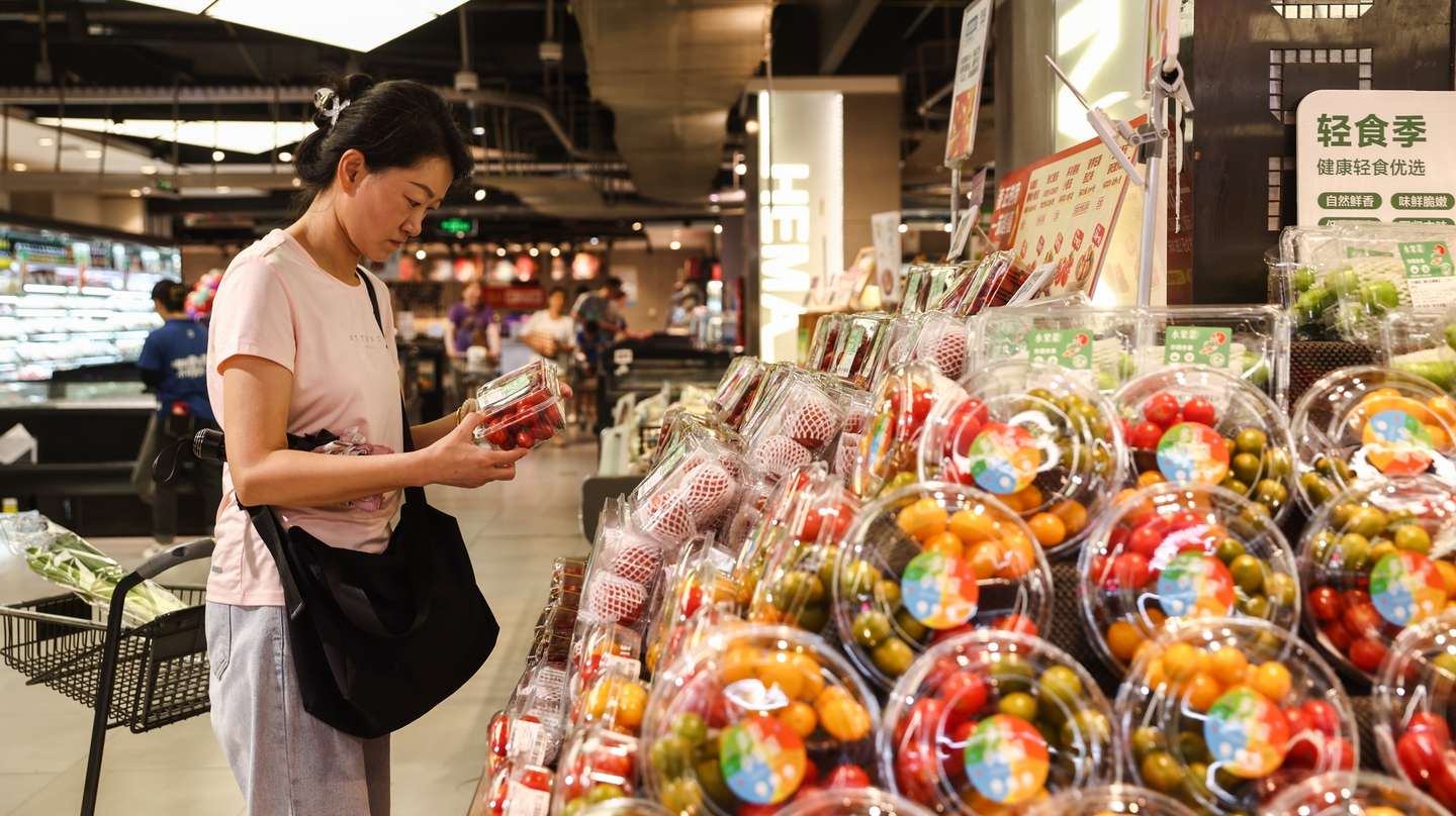 epa11538516 A woman shops in a supermarket in Beijing, China, 09 August 2024. According to a report released on 09 August by the National Bureau of Statistics, China's Consumer Price Index (CPI), which is a main gauge of inflation, rose to 0.5 percent year-on-year in July 2024, from 0.2 percent in the prior month while exceeding market forecasts of 0.3 percent.  EPA/WU HAO