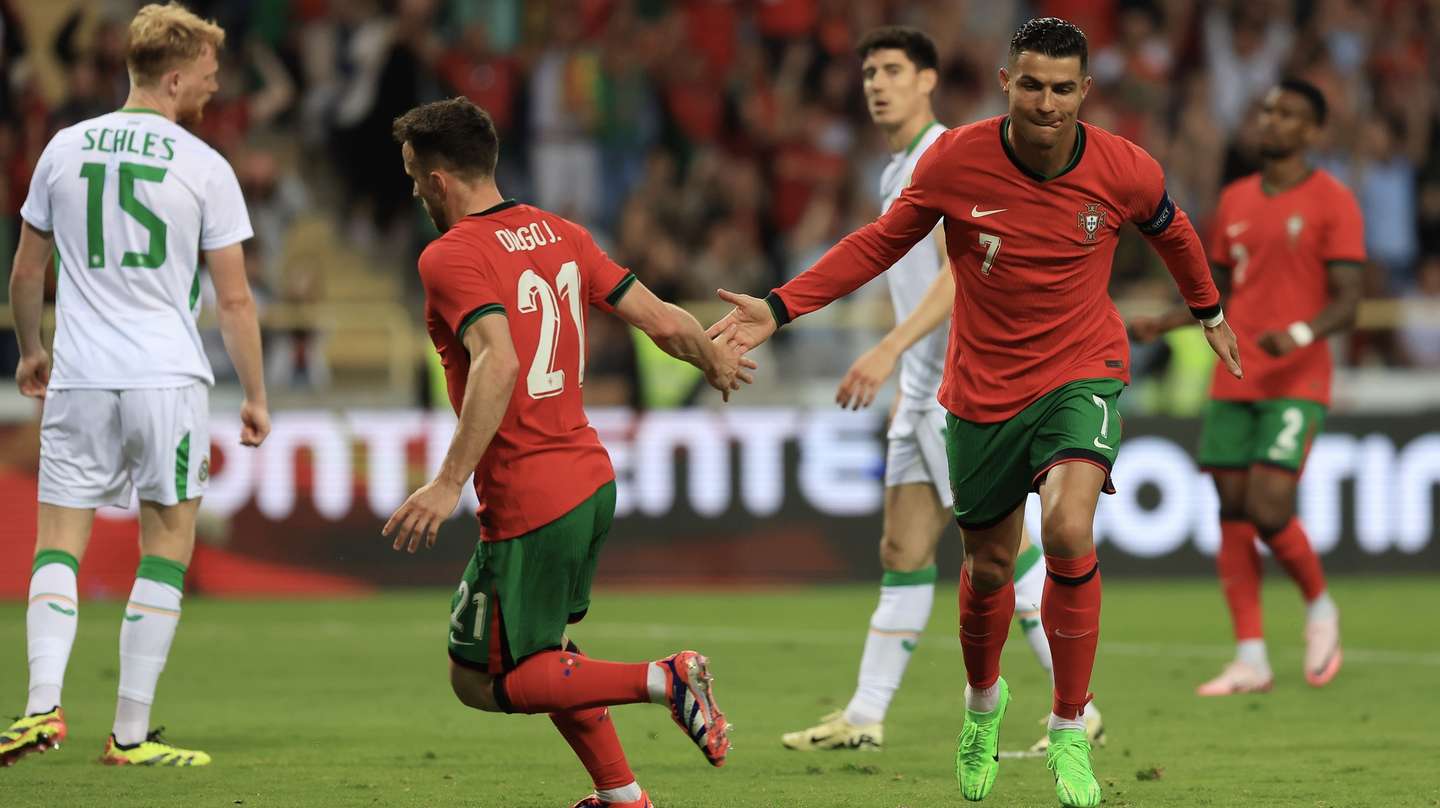 Portugal's Cristiano Ronaldo (R) celebrates with Diogo Jota after scoring a goal against Ireland during their friendly soccer match in preparation for the upcoming Euro 2024, held at Aveiro Municipal stadium, Aveiro, Portugal, 11 June 2024. JOSE COELHO/LUSA