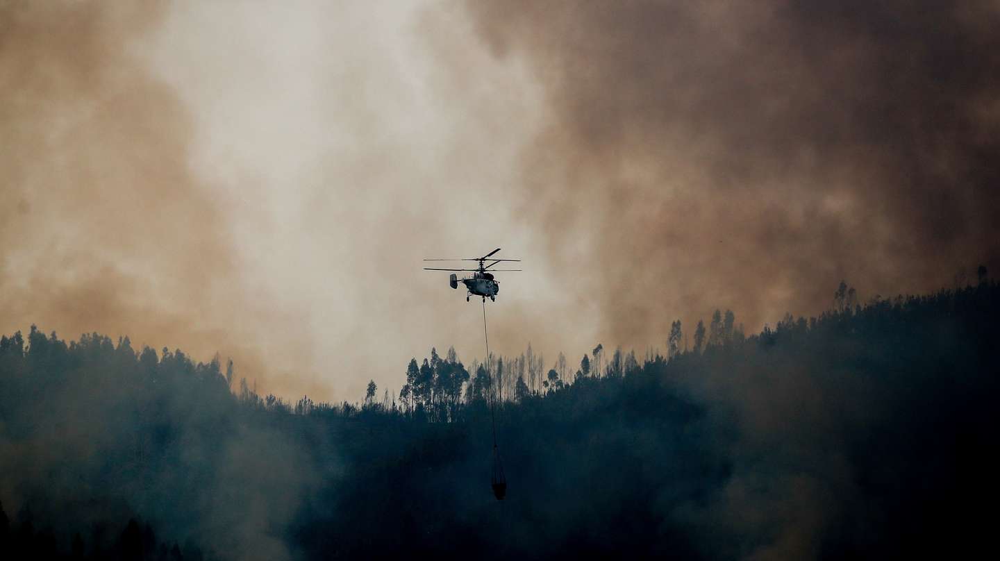 Um helicóptero pesado Kamov durante o combate ao incêndio na encosta da aldeia de Quinta da Tapada, em Oliveira do Hospital, 14 agosto 2025. As frentes de fogo no concelho de Arganil, com início em Piódão, avançaram para norte e noroeste em direção ao município vizinho de Oliveira do Hospital e outra para nordeste, que entrou no concelho de Seia, na região da Guarda, alimentada por ventos fortes e pelas encostas íngremes da serra dos Açores. PAULO CUNHA/LUSA