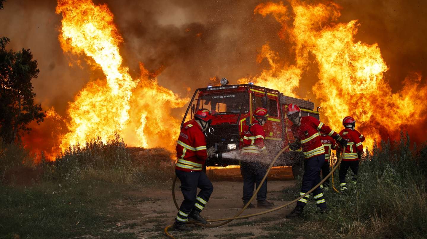 Firefighters battle the flames of the Vouzela fire in Cercosa, a parish in the municipality of Mortagua, Portugal, 4th July 2026. As of early this morning, this fire, which began 48 hours ago in Vouzela, had burnt an area of 12,160 hectares, deploying 1,161 firefighters on the ground and supported by 382 vehicles and 12 aerial resources. PAULO CUNHA/LUSA