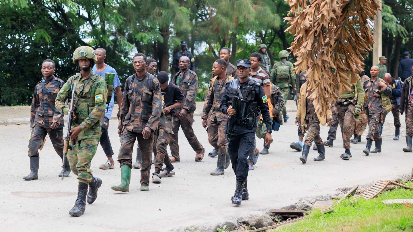 epa11856263 Surrendering members of the Armed Forces of the Democratic Republic of the Congo (FARDC) are escorted by Rwandan soldiers after crossing the border from Goma, in the Democratic Republic of the Congo, to Gisenyi, Rwanda, 27 January 2025. Refugees have been crossing into Rwanda in search of safety as soldiers of the Armed Forces of the Democratic Republic of the Congo (FARDC) and M23 rebels continue to fight in the city of Goma. According to the UN Refugee Agency (UNHCR), violence in the eastern Democratic Republic of the Congo (DRC) has displaced 237,000 people in 2025.  EPA/MOISE NIYONZIMA