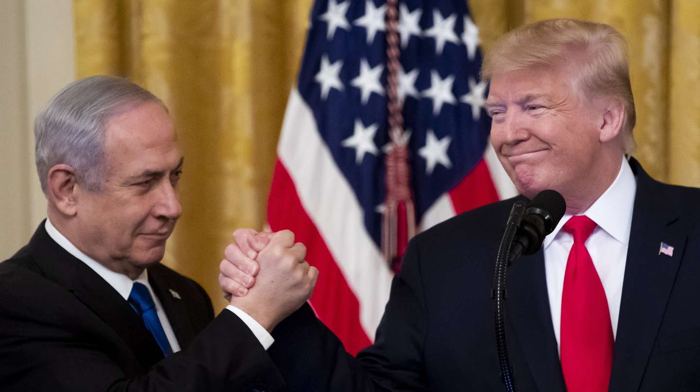 epa08939629 (FILE) US President Donald J. Trump (R) shakes hands with Prime Minister of Israel Benjamin Netanyahu (L) while unveiling his Middle East peace plan in the East Room of the White House, in Washington, DC, USA, 28 January 2020. The presidency of Donald Trump, which records two presidential impeachments, will end at noon on 20 January 2021.  EPA/MICHAEL REYNOLDS *** Local Caption *** 55828472