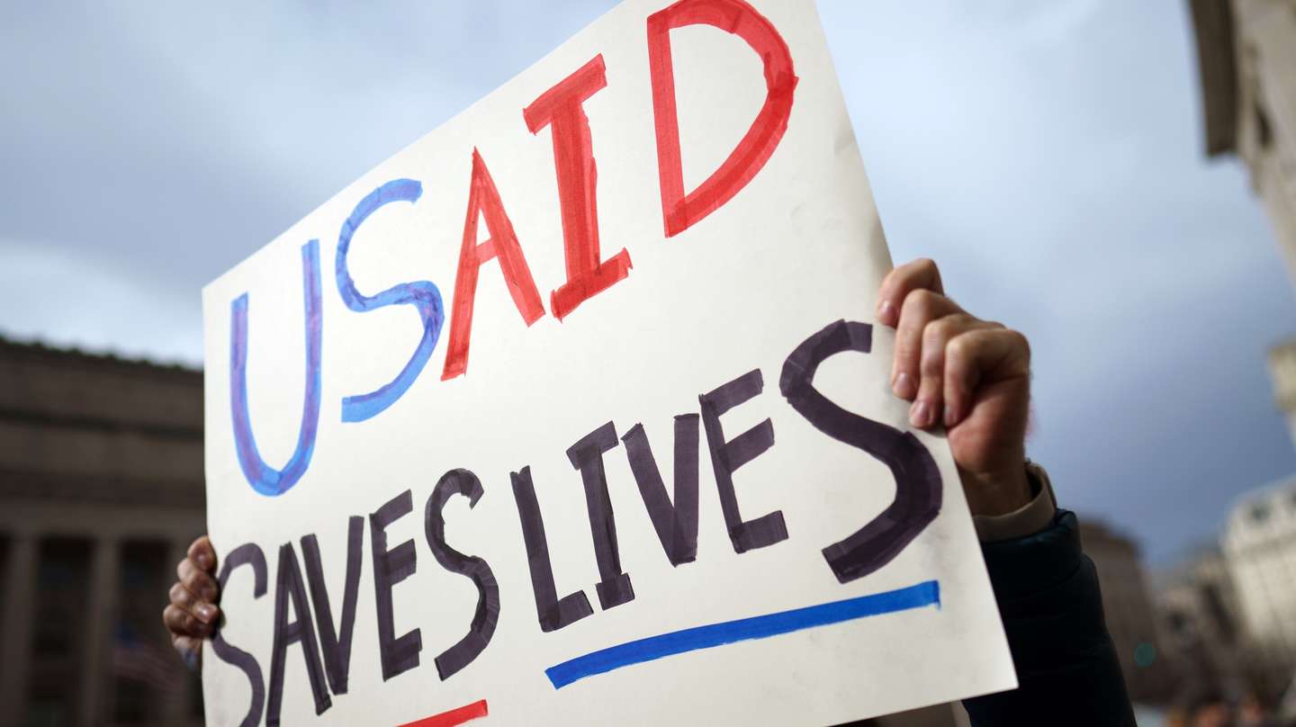 epa11873497 A protester holds a placard outside the US Agency for International Development (USAID) in Washington, DC, USA, 03 February 2025. Staffers at USAID have been instructed via an email to stay away from the agency's Washington headquarters on 03 February 2025, following a weekend takeover by an announcement by US billionaire Elon Musk that President Trump had agreed with him to shut the agency down.  EPA/WILL OLIVER