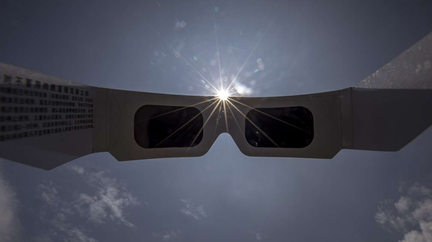 epa08500014 View of an annular partial solar eclipse seen in the clouded in Kathmandu, Nepal, 21 June 2020. A partial solar eclipse occurs when a portion of the Earth is engulfed by the shadow (penumbra) cast by the Moon as it passes between our planet and the Sun in imperfect alignment. During this annular eclipse – the first of the decade – the Moon appears to cover the Sun, leaving the Sun's halo as a visible rim forming an annulus, popularly known as the 'ring of fire.  EPA/NARENDRA SHRESTHA