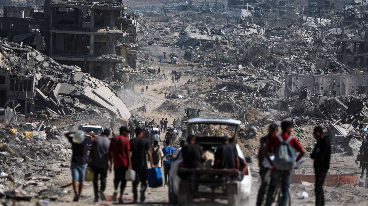 epa12447091 Internally displaced Palestinians walk along a street among the rubble of destroyed buildings amid a ceasefire between Israel and Hamas, in Gaza City, 11 October 2025. US President Donald Trump announced that Israel and Hamas have agreed to the first phase of a Gaza peace plan. The deal involves the release of Israeli hostages and Palestinian prisoners, the withdrawal of Israeli forces, and the delivery of humanitarian aid to Gaza.  EPA/MOHAMMED SABER