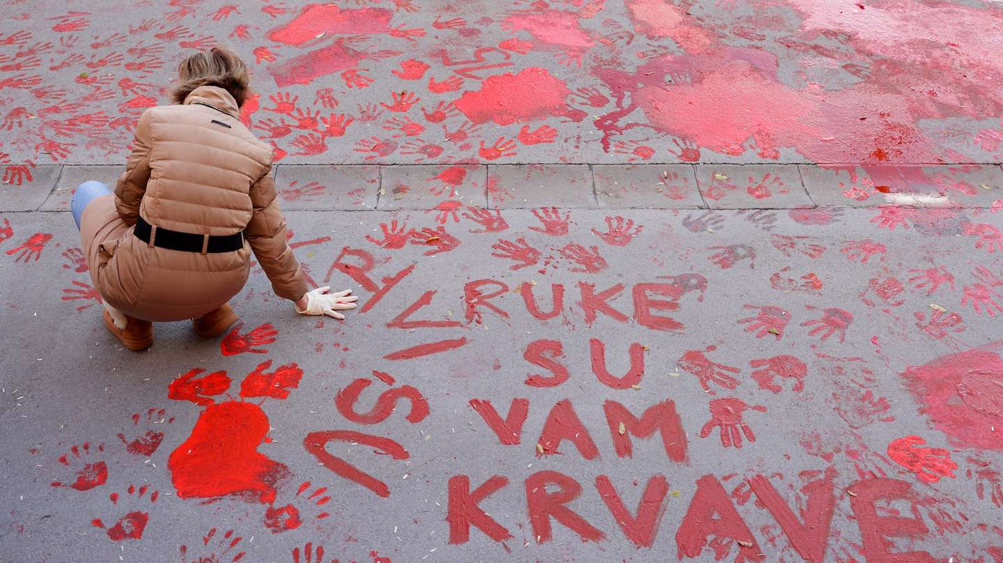 epaselect epa11751325 A protestor paints the pavement with red paint symbolizing blood during the one month anniversary of the Novi Sad train station accident in Novi Sad, Serbia, 01 December 2024. Fifteen people lost their lives in the collapse of the Novi Sad Railway Station canopy on 01 November 2024. The station building, which had been renovated and reopened on 05 July 2024, was undergoing further renovations shortly before the collapse.  EPA/ANDREJ CUKIC