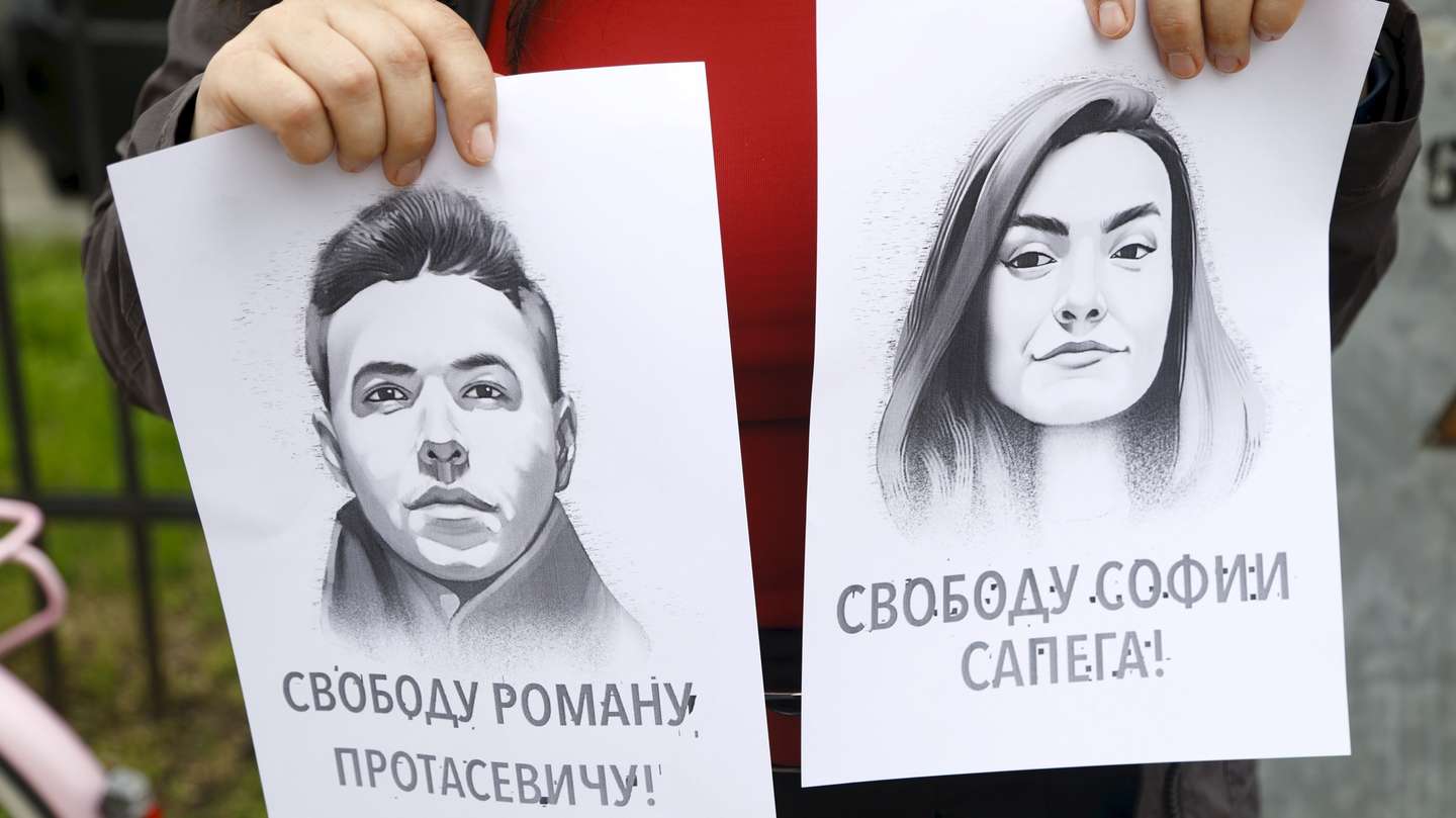 epa09226579 A woman holds a portrait of opposition journalist Roman Protasevich and his girlfriend Sofia Sapega during a protest of solidarity with Roman Protasevic at the Belarusian embassy in Riga, Latvia, 25 May 2021. Belarus' opposition journalist Roman Protasevich was detained by Belarusian Police on 23 May on a Ryanair flight from Athens to Vilnius, that was forced to land in Minsk.  EPA/TOMS KALNINS