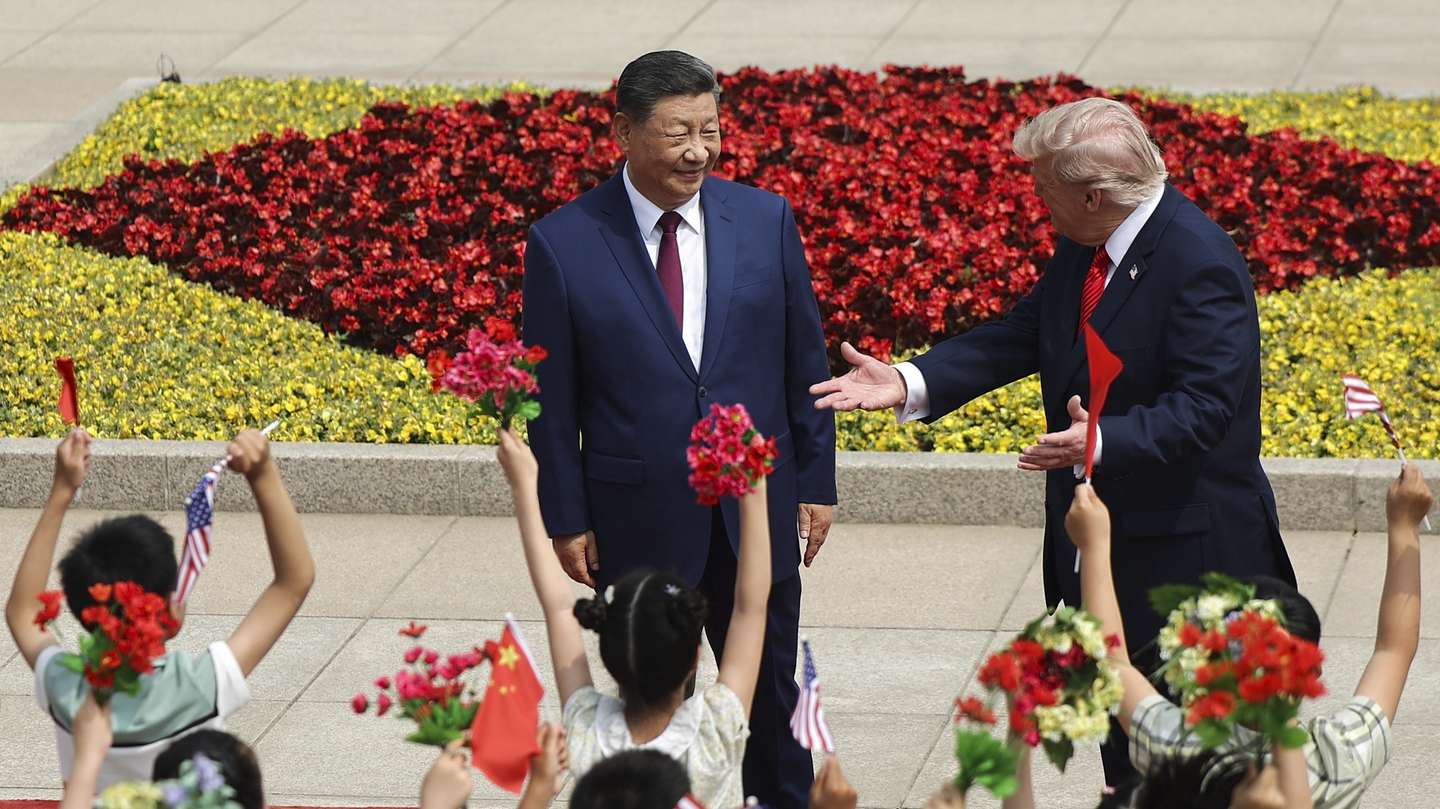 epa12955676 Children hold Chinese and U.S. flags as U.S. President Donald Trump participates in a welcome ceremony with Chinese President Xi Jinping at the Great Hall of the People in Beijing, China, 14 May 2026.  EPA/Maxim Shemetov / POOL