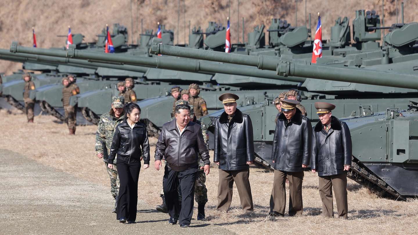 epa12835186 A photo released by the official Korean Central News Agency (KCNA) shows shows North Korean leader Kim Jong Un (2-L) and his daughter Kim Ju Ae (L) visiting the Pyongyang Training Base No. 60 of the Capital City Defence Corps of the North Korean Army in North Korea, 19 March 2026 (issued 20 March 2026). According to KCNA, the tactical drill was designed to train sub-units in coordinated offensive maneuvers involving tanks and infantry to seize enemy anti-armor defense lines.  EPA/KCNA  EDITORIAL USE ONLY