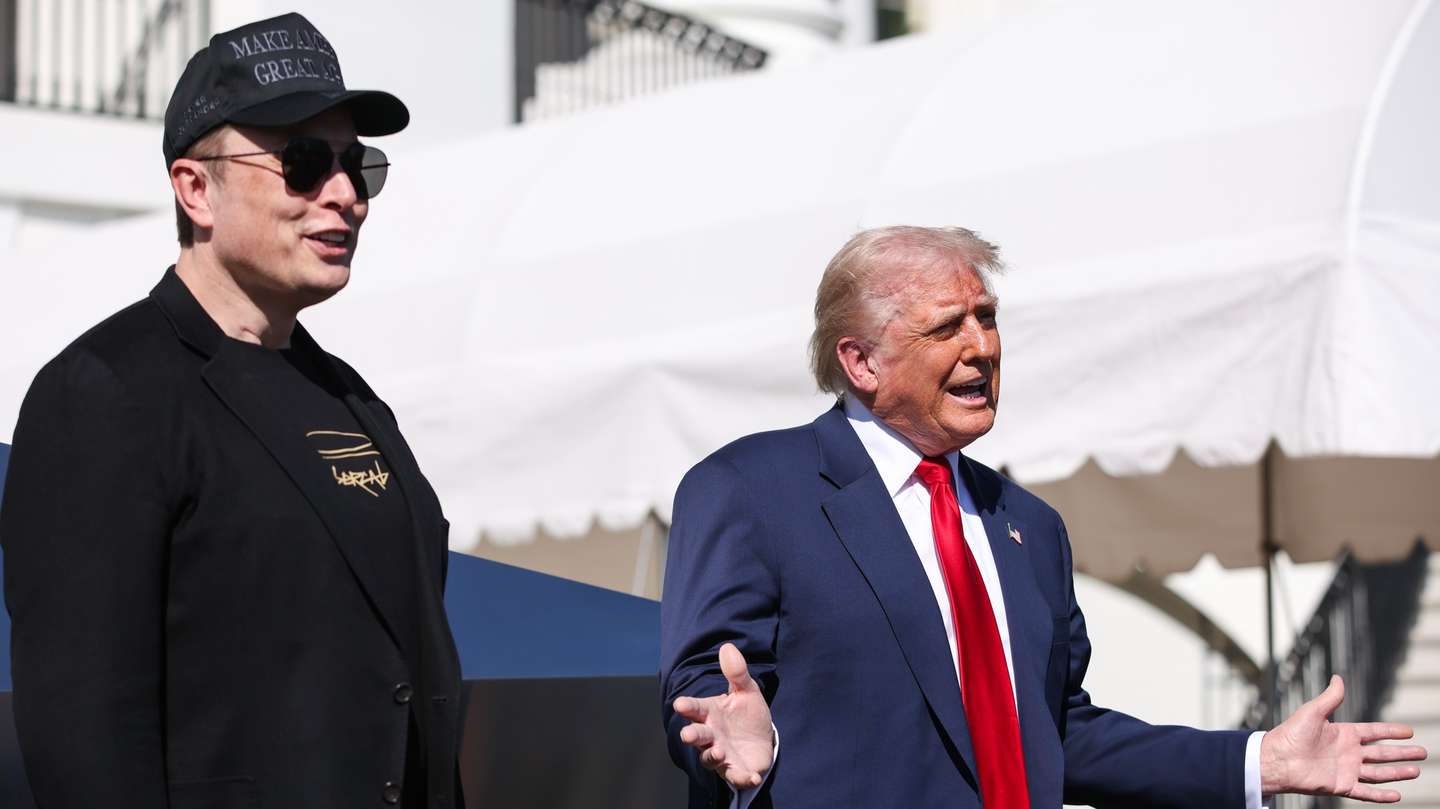 epa11956958 Tesla CEO and Senior Advisor to the President of the United States Elon Musk (L) looks on as US President Donald Trump (R) speaks in front of Tesla vehicles at the White House in Washington, D.C., USA, 11 March 2025. President Trump has said he will buy a Tesla to support Tesla and Elon Musk after recent attacks on Tesla charging stations and calls for boycotts of Tesla products.  EPA/SAMUEL CORUM / POOL