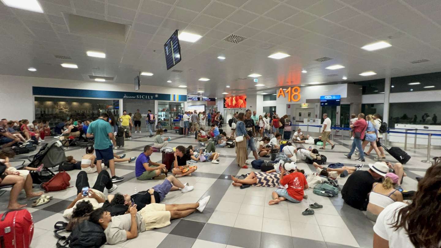 epa11488441 Passengers lay on the floor as they wait to board at Palermo airport, Sicily island, Italy, 19 July 2024. Operations at various airports and airlines have reported being impacted by a global tech outage in systems running Microsoft Windows linked to a faulty CrowdStrike cyber-security software update. According to CrowdStrikeâ€™s CEO, the issue has been identified, isolated and a fix has been deployed. Airlines in Europe, Asia, the Middle East and North America have reportedly been impacted and some businesses have also been affected.  EPA/IGOR PETYX
