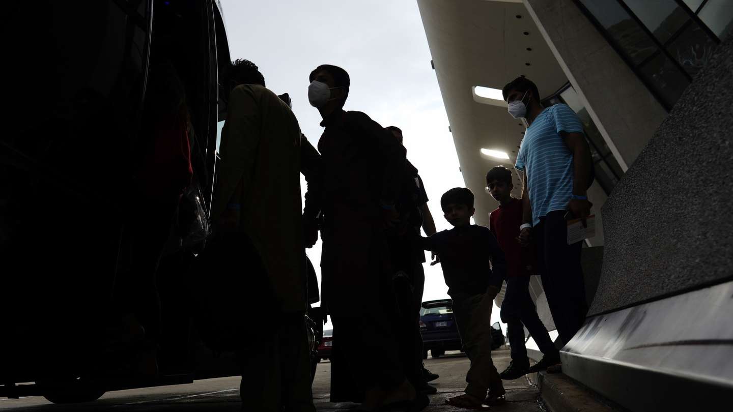 epa09430612 Afghans evacuated from Kabul, Afghanistan board a bus following their arrival at Washington Dulles International Airport in Chantilly, Virginia, USA, 26 August 2021. Western governments continue to airlift Afghans and their citizens from Afghanistan ahead of the 31 August deadline for US troops withdrawal.  EPA/WILL OLIVER