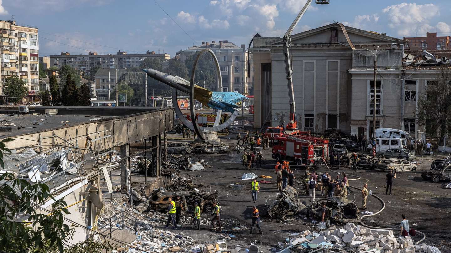 epa10071547 Firefighters together with rescuers, military and the police work at the site of the Russian missile strike in downtown Vinnytsia, west-central Ukraine, 14 July 2022. At least 23 people, including three children, were killed and more than 100 injured as a result of Russian missile strikes in the city of Vinnytsia, Ukrainian authorities said.  EPA/ROMAN PILIPEY