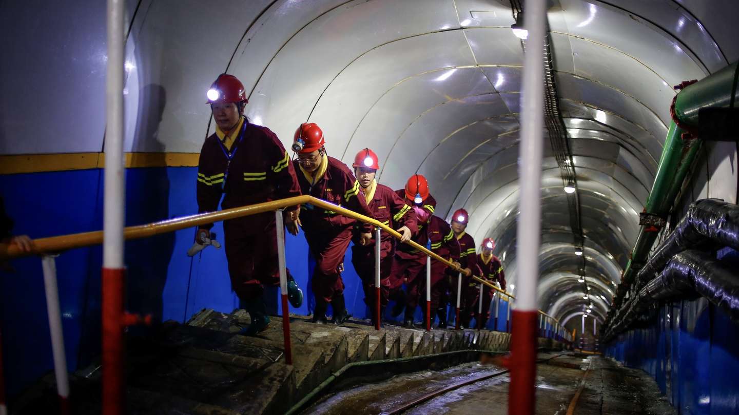 epa10755240 People walk up a mining site during an organized media tour at the Lilou Coal Mine in Heze, Shandong province, China, 19 July 2023. Members of the press visited the Lilou Coal Mine to view the first commercial application of artificial intelligence (AI) for the mining industry called the Pangu Mine Model. The AI model is capable of visual recognition capabilities, analyzing the quality of stress relief drilling, and can assist in rock burst prevention personnel in quality verification, reducing the review workload by 82 percent, shortening the check to 10 minutes from three days with 100 percent acceptance rate.  EPA/MARK R. CRISTINO
