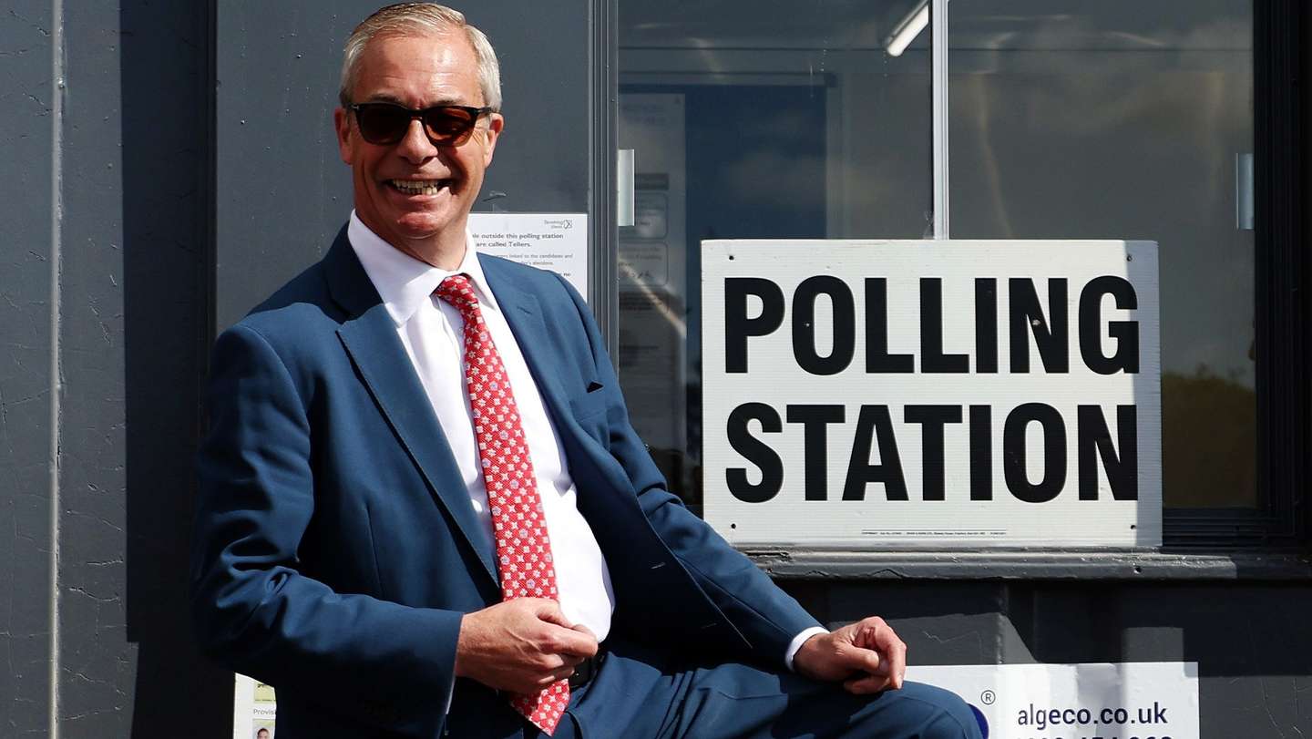 epa12938525 Reform UK leader Nigel Farage shows off his Union flag socks after voting in local elections in Clacton-on-Sea, Britain, 07 May 2026. Millions of Britons are voting across the country in local elections on 07 May.  EPA/ANDY RAIN