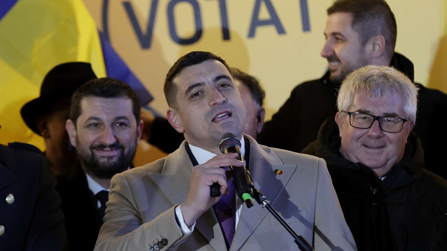 epa11752525 The leader of the ultra-nationalist party AUR (Alliance for the Union of Romanians), George Simion (C), surrounded by top party members, speaks at the AUR campaign headquarters after the first exit-poll for parliamentary elections was announced, in Bucharest, Romania, 01 December 2024.  EPA/ROBERT GHEMENT
