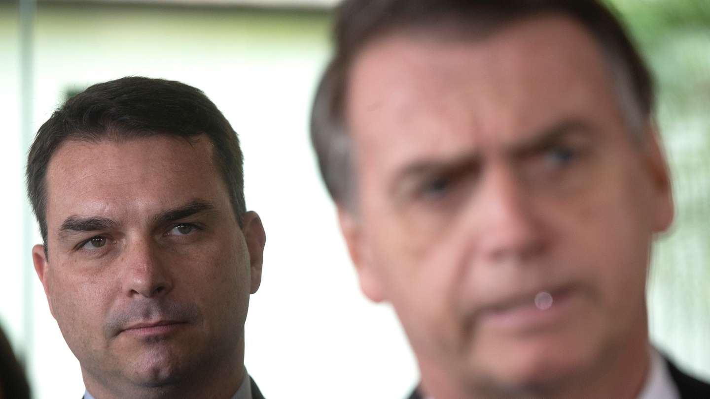 epa08628612 (FILE) - Then Brazilian President-elect Jair Bolsonaro (R) and his son, then elected senator Flavio Bolsonaro (L), arrive at the Supreme Court of Justice for a press conference in Brasilia, Brazil, 07 November 2018 (reissued 27 August 2020). According to the senator's office statement, the eldest son of Brazilian President Jair Bolsonaro, Senator Flavio Bolsonaro, said he has tested positive for the new coronavirus.  EPA/Joedson Alves *** Local Caption *** 54757503
