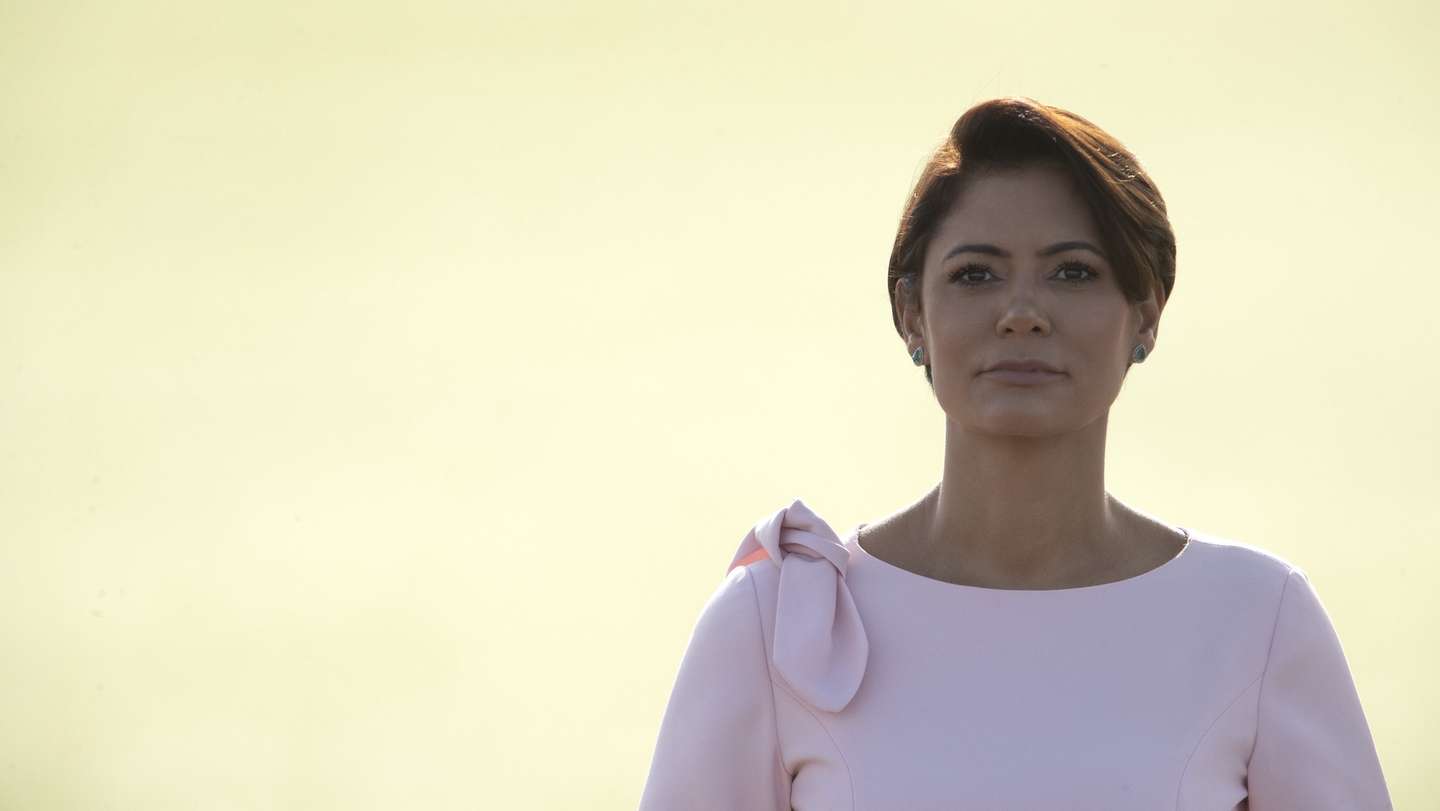 epa09810342 Brazil's first lady Michelle Bolsonaro is seen after a ceremony to raise the national flag in honor of International Women's Day, at the Palacio da Alvorada in the city of Brasilia, Brazil, 08 March 2022. The first lady mentioned in a brief speech that her husband is 'the most rosy president in the world.'  EPA/Joedson Alves