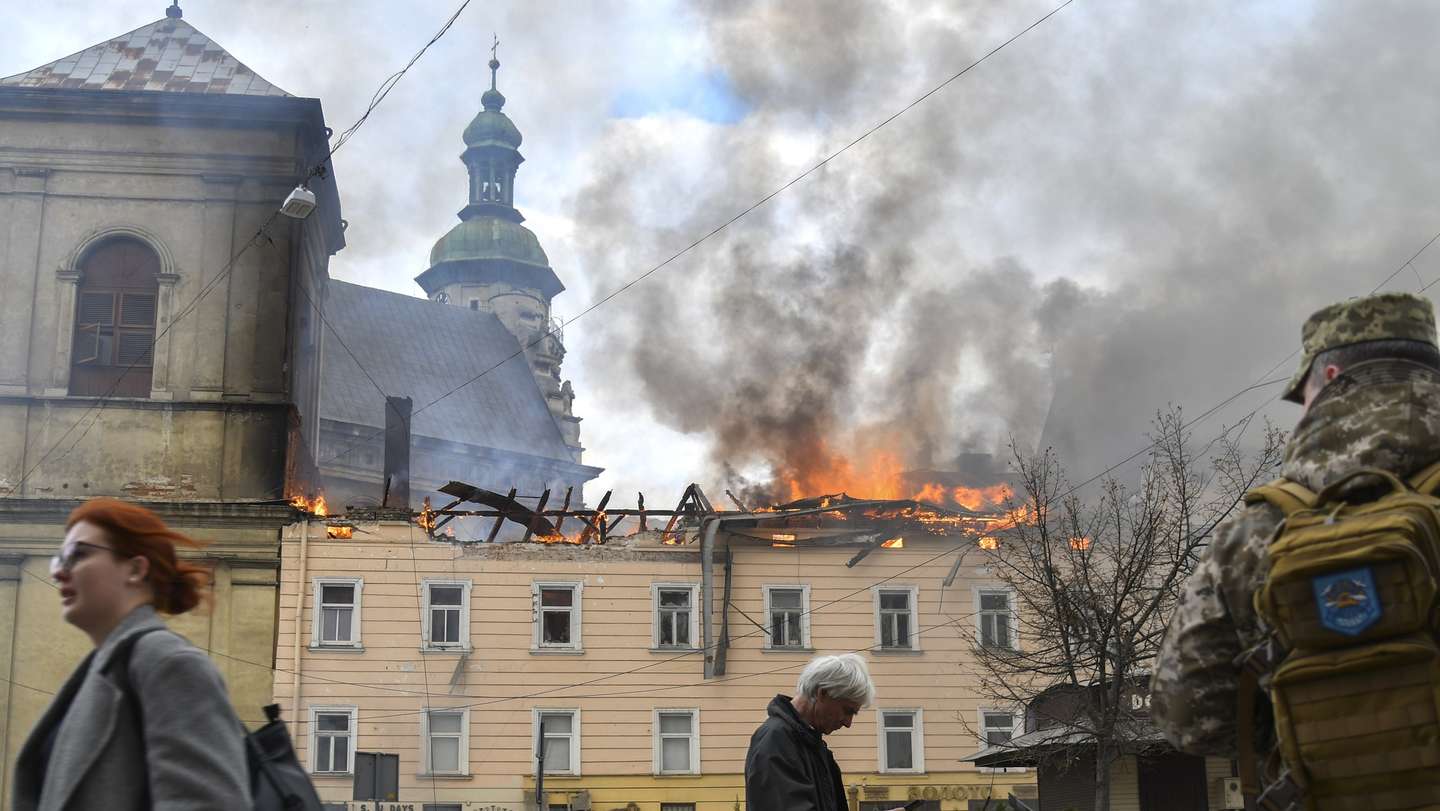 epaselect epa12846807 Pedestrians walk past the site of a Russian drone attack on the historic center of Lviv, in western Ukraine, 24 March 2026. Russia launched a massive 24-hour aerial assault on Ukraine involving hundreds of drones, leaving over a dozen people injured in the western city of Lviv.  EPA/MYKOLA TYS