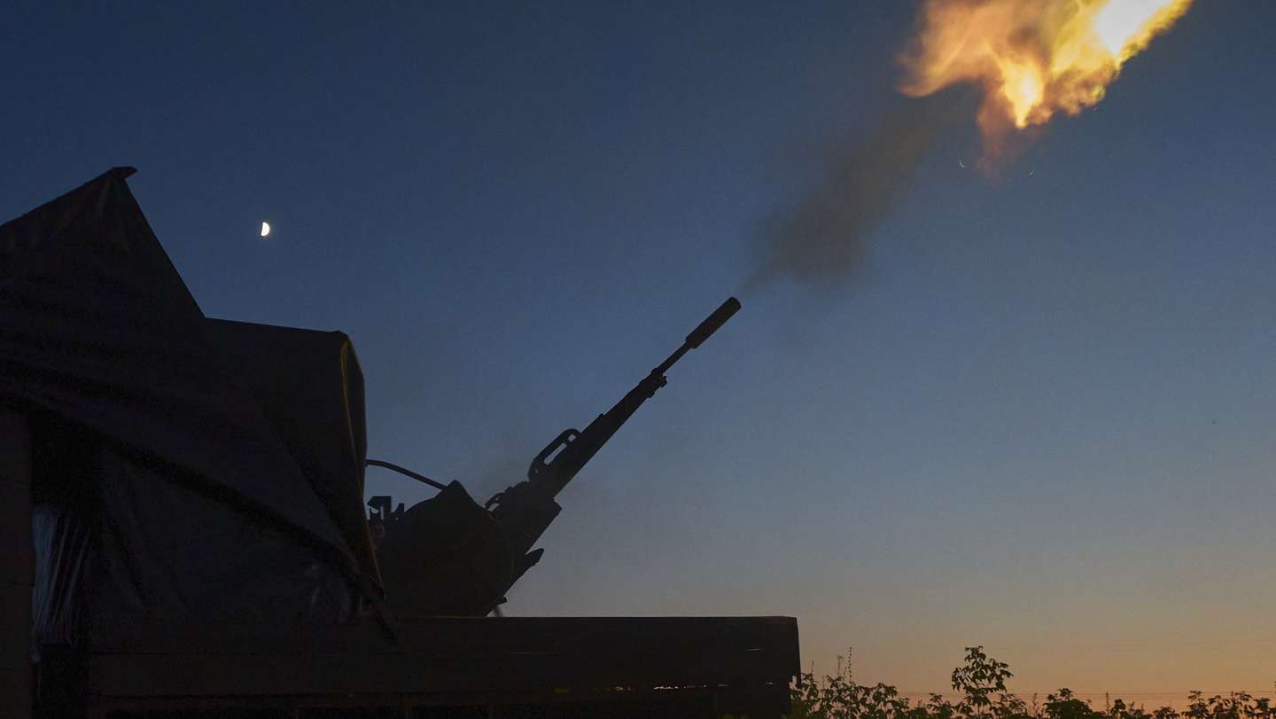 epa12212749 Ukrainian servicemen from the anti-drone mobile fire team shoot at a Russian drone flying toward Kharkiv, with a ZU-23 anti-aircraft twin-barreled autocannon in the Kharkiv region of Ukraine, late evening of 02 July 2025 (issued on 03 July 2025), amid the ongoing Russian invasion.  EPA/SERGEY KOZLOV