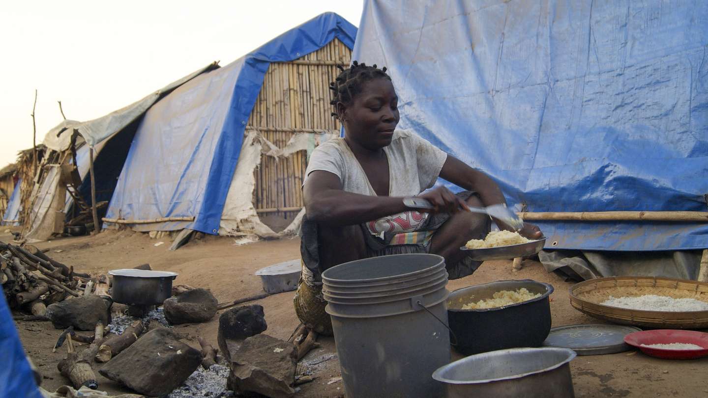 A woman prepares a meal in one of the shelter camps in Metuge, a space housing displaced people fleeing armed violence in northern Mozambique. Cabo Delgado, Mozambique, 16 August 2021 (issue on 17 August 2021). Following the attacks, which have terrorized Cabo Delgado province since 2017, there are more than 3,100 deaths, according to the ACLED conflict registration project, and more than 817,000 displaced people, according to Mozambican authorities. LUISA NHANTUMBO/LUSA