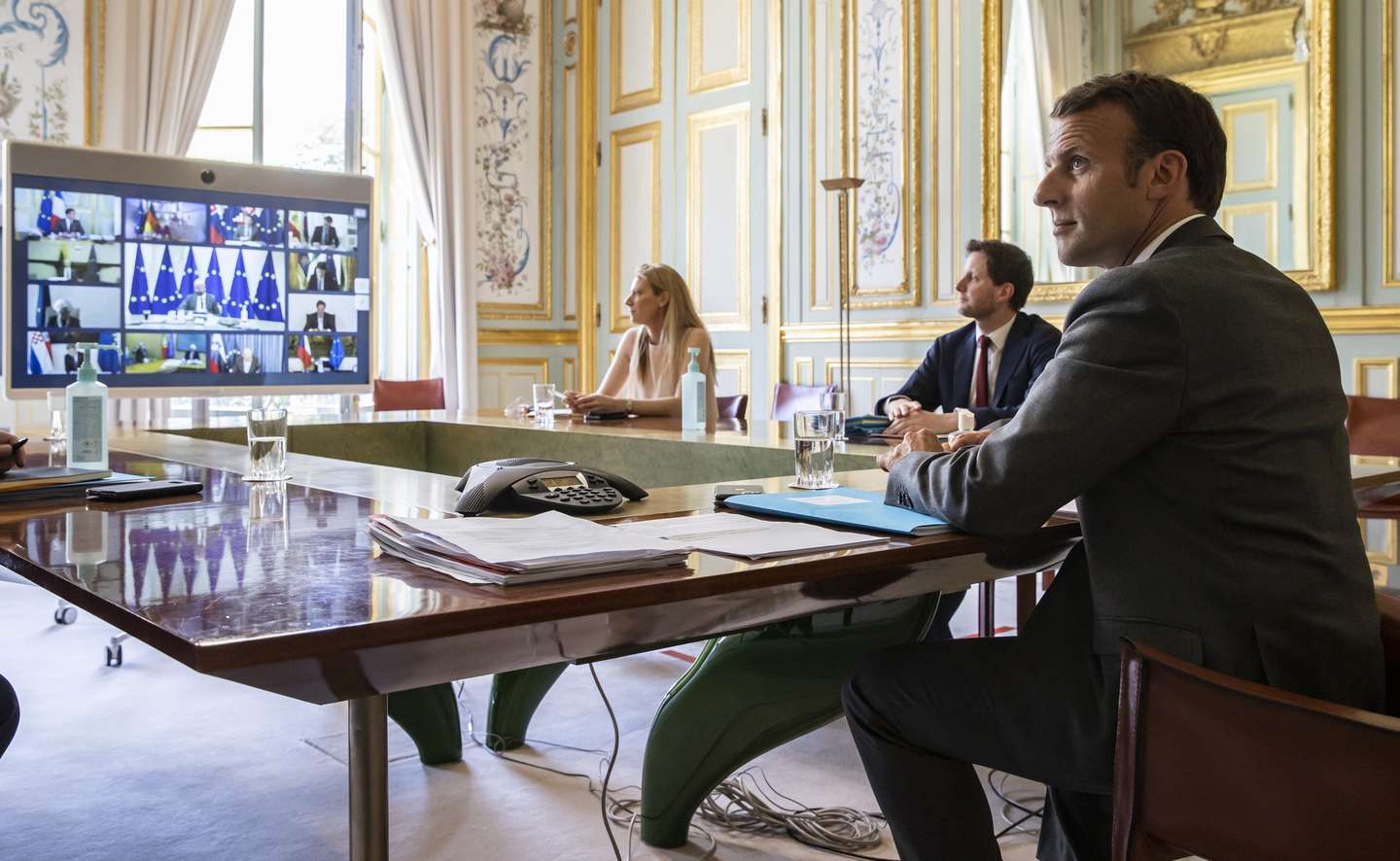 epa08379772 French President Emmanuel Macron (R) attends a video conference call with members of the European Council at the Elysee Palace in Paris, France, 23 April 2020. Countries around the world are taking increased measures to stem the widespread of the SARS-CoV-2 coronavirus which causes the COVID-19 disease.  EPA/IAN LANGSDON / POOL