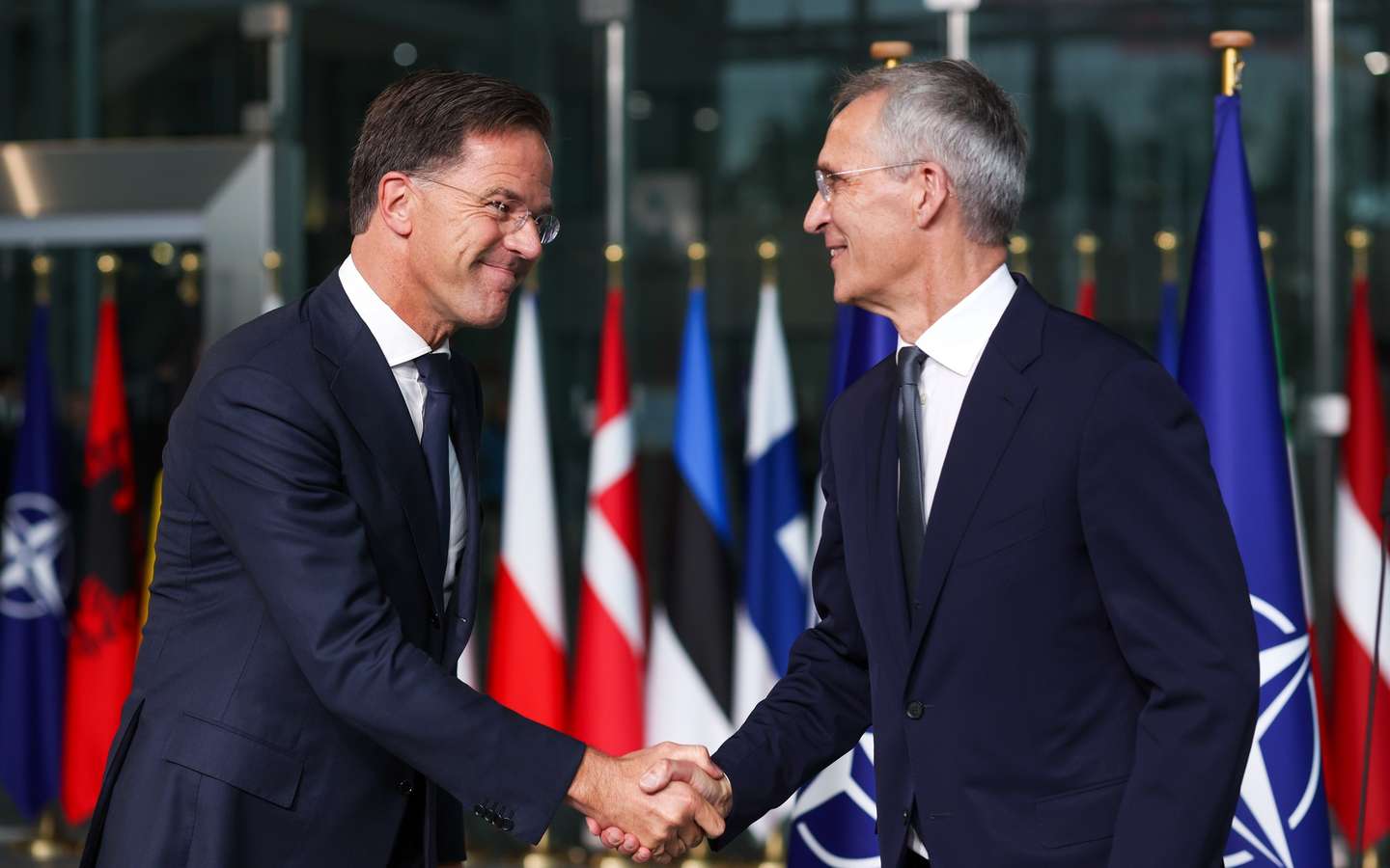 epa11634716 Former Dutch Prime Minister Mark Rutte (L) and Jens Stoltenberg shake hands on the day Rutte succeeds Stoltenberg as NATO Secretary General, at the Alliance headquarters in Brussels, Belgium, 01 October 2024. Former Dutch Prime Minister Mark Rutte succeeds Jens Stoltenberg as Secretary General of the North Atlantic Treaty Organization (NATO) on 01 October 2024 after the latter's ten years at the helm of the Alliance.  EPA/OLIVIER HOSLET