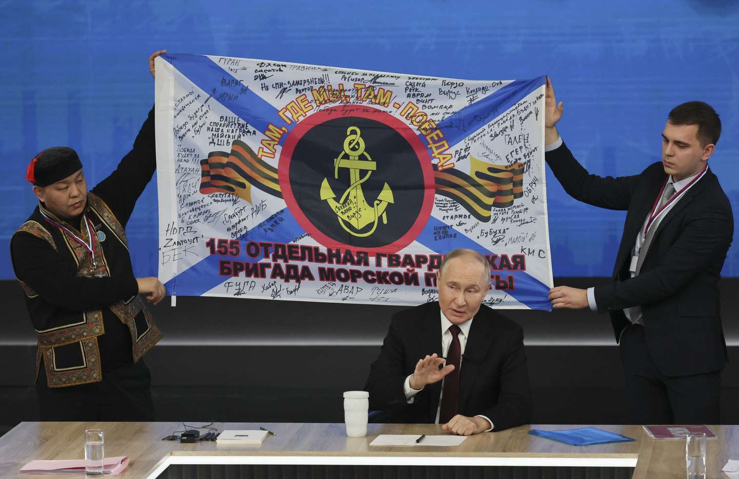 epa11785211 Russian President Vladimir Putin speaks during his annual press conference at the Gostiny Dvor forum hall in Moscow, Russia, 19 December 2024, with a flag of the 155th Marine Brigade of the Pacific Fleet received as a gift from soldiers is displayed behind him. Russian President Vladimir Putin on 19 December holds his end-of-year press conference and the 'Direct Line with Vladimir Putin' televised event, where he will answer citizens' questions focusing on domestic issues.  EPA/YURI KOCHETKOV