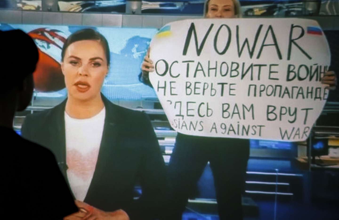 epa09826233 A woman watches a recorded feed of the Russian Channel One's evening news broadcast TV show in which an employee enters Ostankino on-air TV studio with a poster reading ''No War. Stop the war. Don't believe the propaganda. You are being lied to here" in Moscow, Russia, 15 March 2022. The on-air protest was staged on 14 March by Marina Ovsyannikova, who worked as an editor. She was taken to the Ostankino police department. A protocol was drawn up against an employee of Channel One under the article on military censorship for discrediting the Russian armed forces. On 24 February Russian troops had entered Ukrainian territory in what the Russian president declared a 'special military operation', resulting in fighting and destruction in the country, a huge flow of refugees, and multiple sanctions against Russia.  EPA/DSK