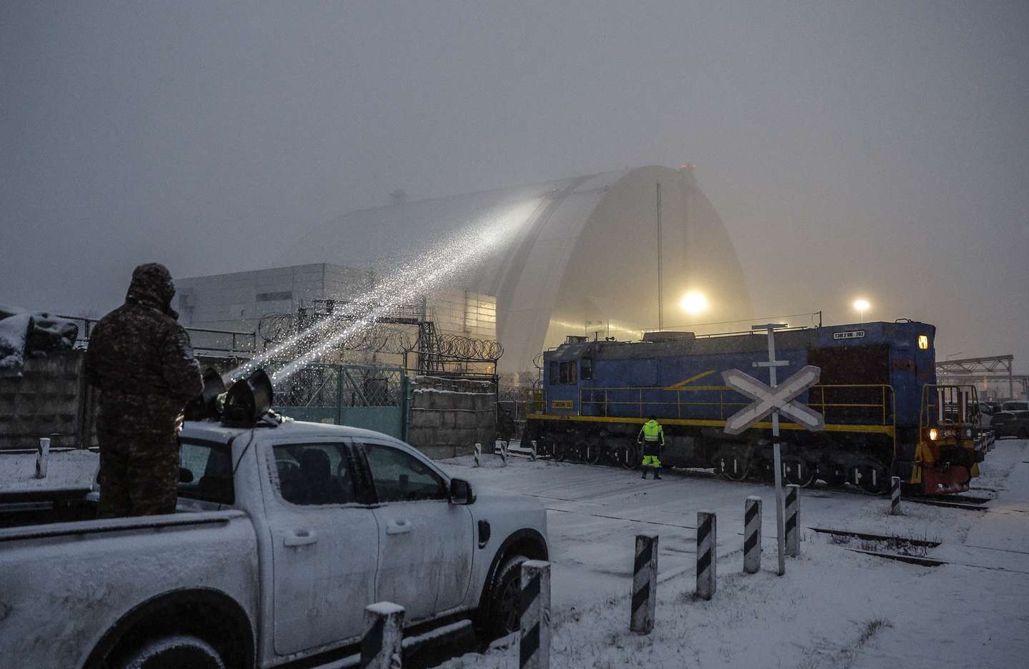epaselect epa11896527 A Ukrainian serviceman directs a light towards a damaged protective shelter over the remains of the reactor Unit 4 at the Chernobyl nuclear power plant (NPP), near the city of Chernobyl, Ukraine, 14 February 2025, amid the Russian invasion. Ukraine's President Zelensky said on 14 February, that a Russian drone with a 'high-explosive warhead' struck the shelter covering the destroyed Unit 4 of the Chernobyl NPP overnight. A fire was extinguished and radiation levels are being monitored at the site, Ukrainian authorities said.  EPA/SERGEY DOLZHENKO