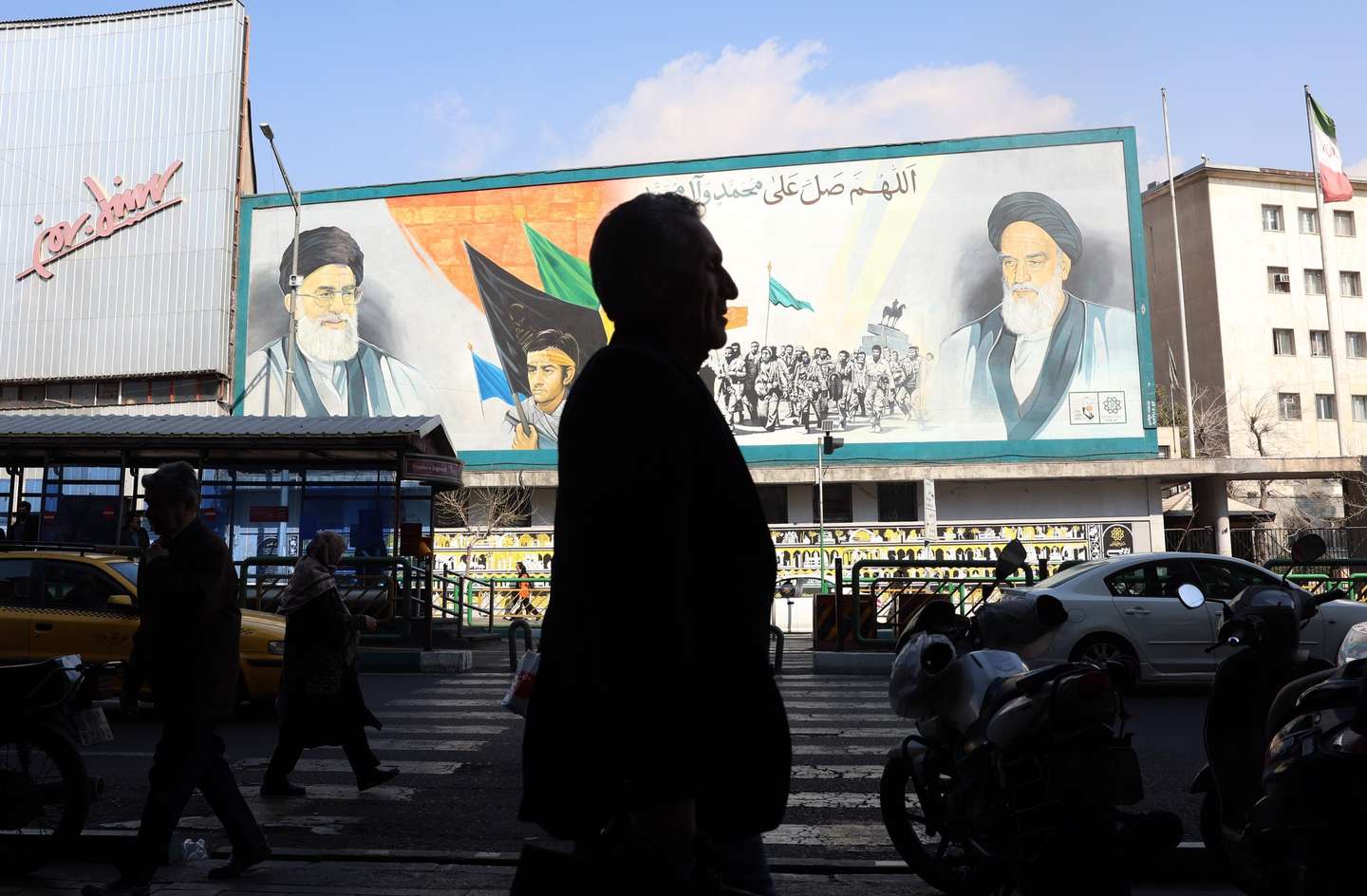epa12775527 Iranians walk next to a wall painting of Iranian Supreme Leader Ayatollah Ali Khamenei (top-L) and late leader Ayatollah Ruhollah Khomeini (top-R) on a street in Tehran, Iran, 25 February 2026. As Iran and the US are set to hold another round of talks in Geneva on 26 February, US President Donald Trump said the US will not allow Iran to have nuclear weapons.  EPA/ABEDIN TAHERKENAREH