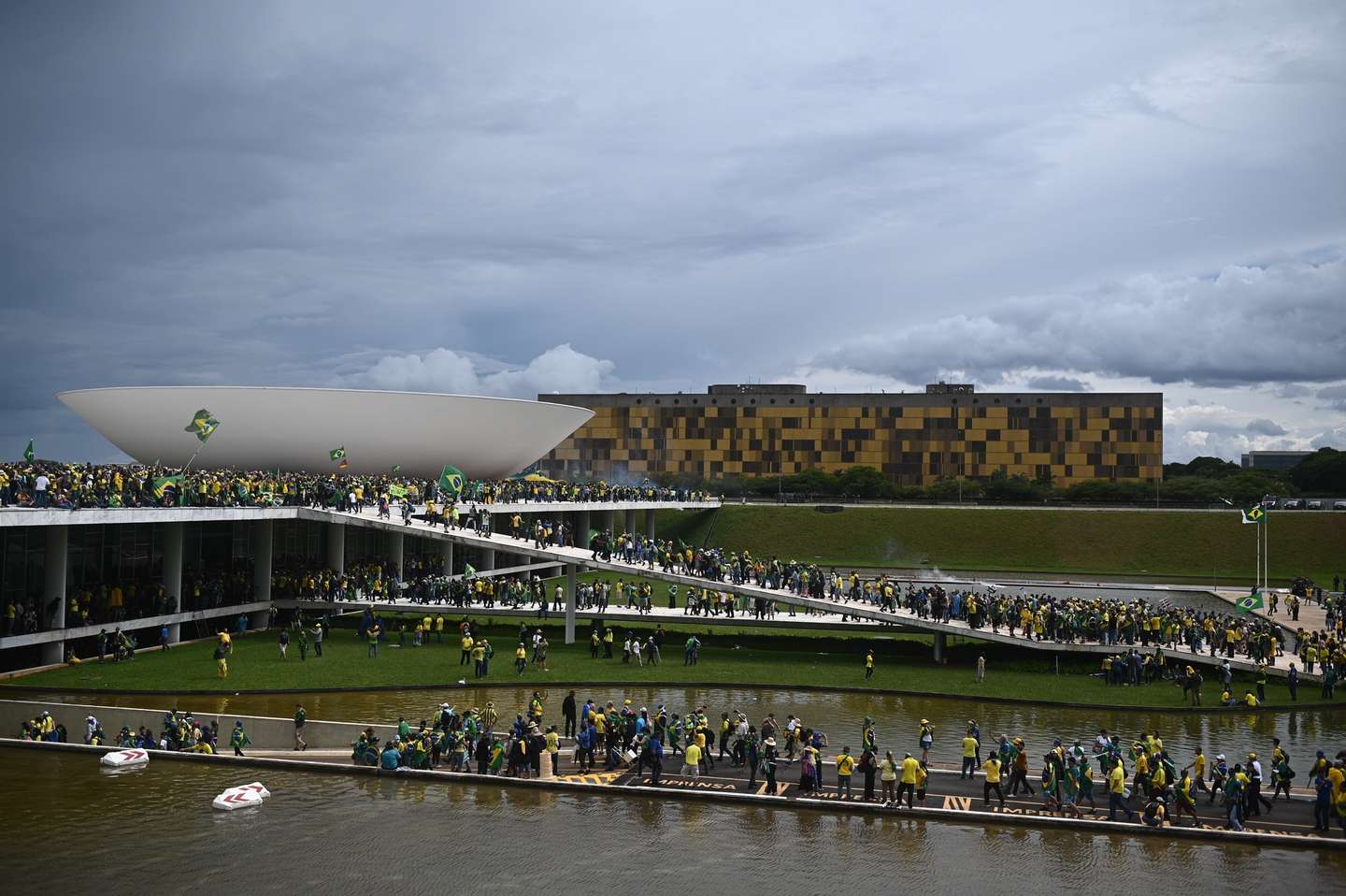 epa10396225 Bolsonaro supporters storm the National Congress in Brasilia, Brazil, 08 January 2023. Hundreds of supporters of former Brazilian President Jair Bolsonaro invaded the headquarters of the National Congress, and also Supreme Court and the Planalto Palace, seat of the Presidency of the Republic, in a demonstration calling for a military intervention to overthrow President Luiz Inacio Lula da Silva. The crowd broke through the cordons of security forces and forced their way to the roof of the buildings of the Chamber of Deputies and the Senate, and some entered inside the legislative headquarters.  EPA/ANDRE BORGES