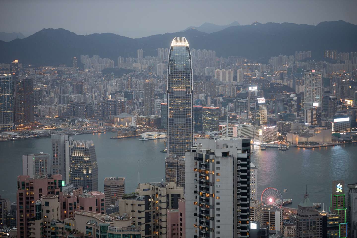 epa08350407 Aerial view of the commercial and residential buildings that make up the skylines of Hong Kong Island (foreground) and the Kowloon Peninsula (background), in Hong Kong, China, 08 April 2020. The Hong Kong Special Administrative Region's government has announced it is set to roll out a stimulus package worth 137 billion HK dollars (about 17.7 billion US dollars) with measures to help businesses and workers during the ongoing pandemic of the COVID-19 disease caused by the novel SARS-CoV-2 coronavirus.  EPA/JEROME FAVRE