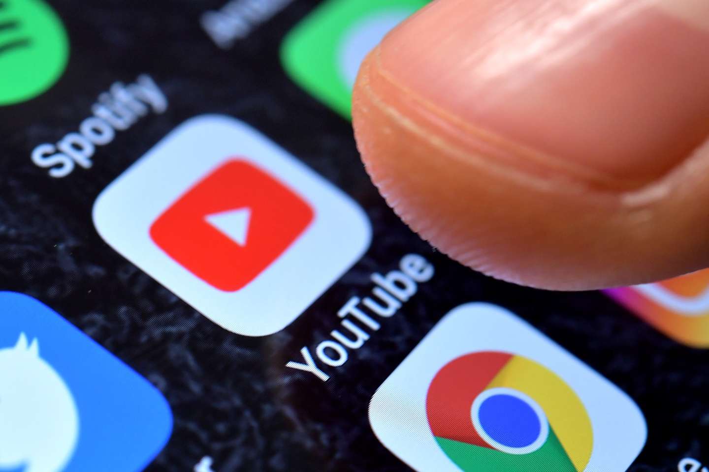 epa08934619 (FILE) - A close-up image shows the YouTube app on an iPhone in Kaarst, Germany, 08 November 2017 (reissued 13 January 2021). YouTube announced on 12 January 2021 that it temporarily suspended US President Donald J. Trump's account for a minimum of seven days citing concerns about the potential of violence following riots at the US Capitol in Washington, DC, USA last week. The Google-owned video-sharing service follows other social media and online services limiting the president's online activities. The suspension temporarily prevents Trump's channel from uploading new videos or live-streaming material, even though the channel continues to be live.  EPA/SASCHA STEINBACH *** Local Caption *** 53883779
