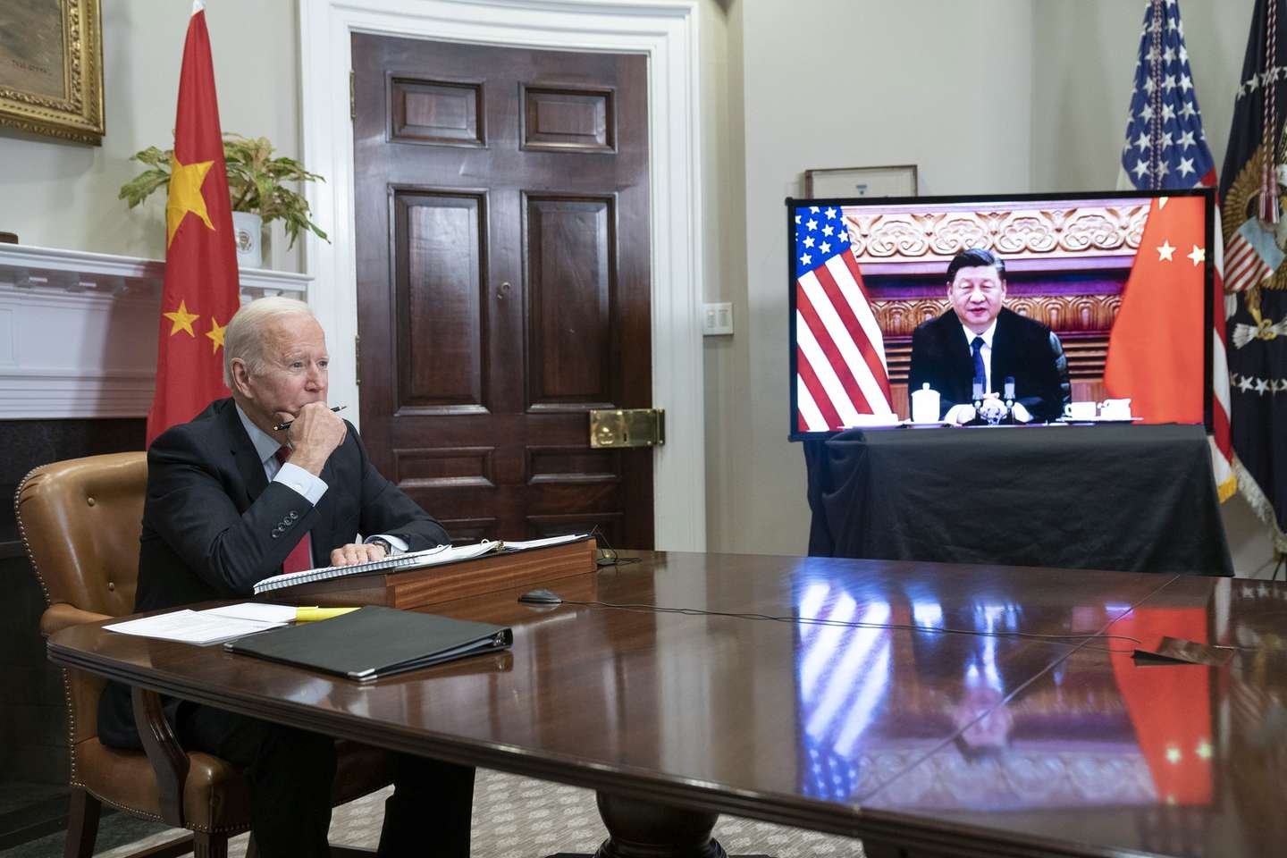 epa09584529 US President Joe Biden listens during a virtual summit with Chinese President Xi Jinping in the Roosevelt Room of the White House in Washington DC, USA, 15 November 2021.  EPA/SARAH SILBIGER / POOL