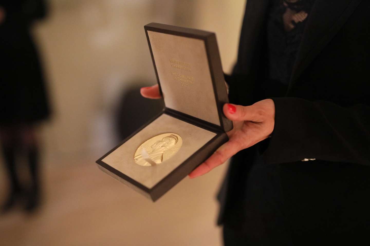 epa08869369 A handout photo made available by The Nobel Prize shows the Nobel Prize medal and diploma being presented to chemistry laureate Emmanuelle Charpentier at the Swedish Ambassador's Residence in Berlin, Germany, 07 December 2020.  EPA/BERNHARD LUDEWIG / THE NOBEL PRIZE HANDOUT MANDATORY CREDIT: THE NOBEL PRIZE HANDOUT EDITORIAL USE ONLY/NO SALES